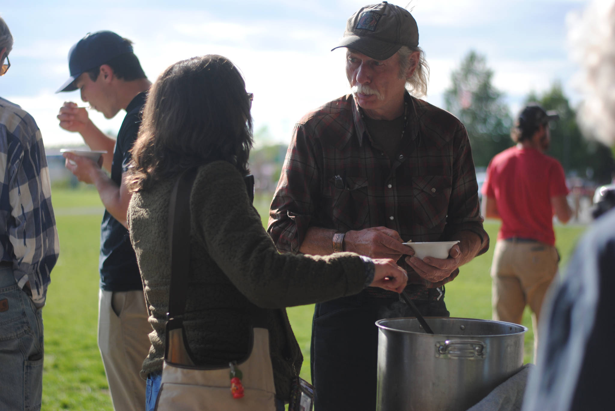 Steve Schoonmaker of Kasilof serves salmon chowder to Diane Taylor of Kasilof at Soldotna Creek Park in celebration of Alaska Wild Salmon Day, an annual event to recognize the importance of the unique Alaska resource. “I’m here to show respoect for these honorable creatures,” Schoonmaker said. “&