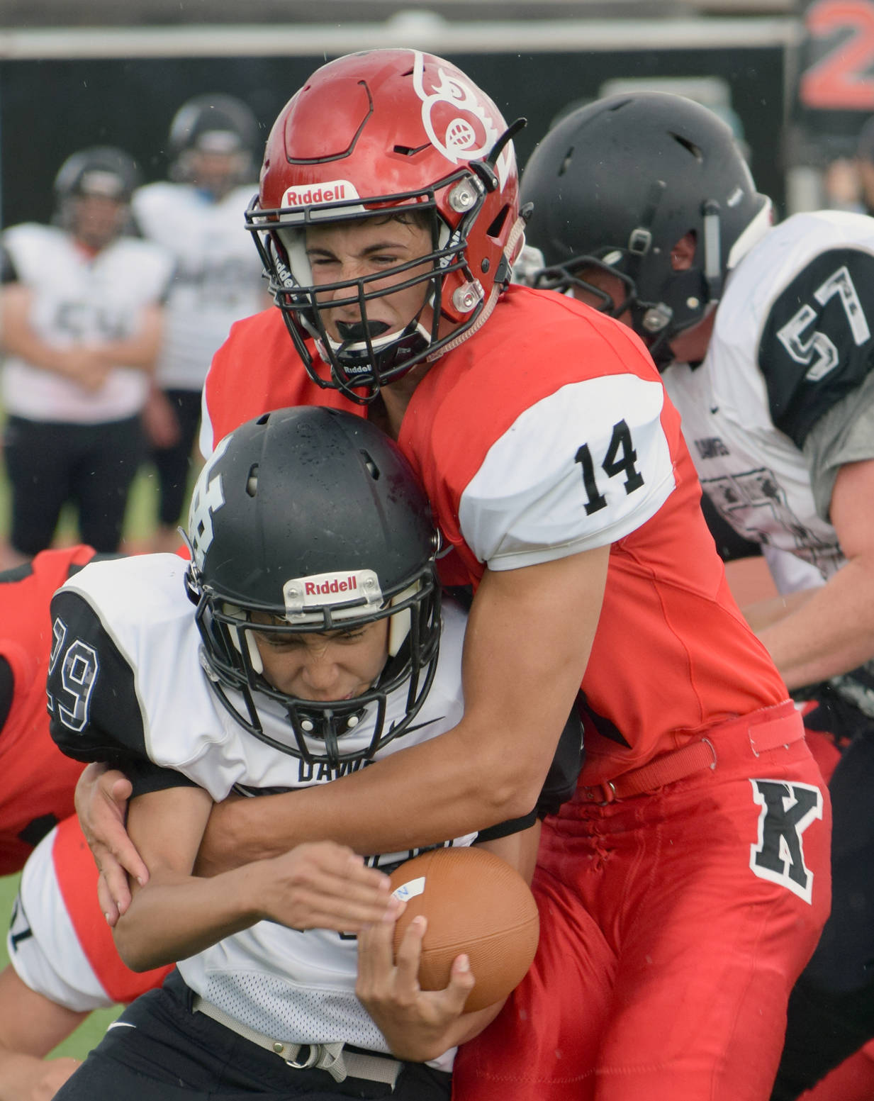 Kenai Central’s Logan Baker stuffs Nikiski’s Jim Lamping for a loss Friday, July 11, 2017, during a scrimmage at Ed Hollier Field in Kenai. (Photo by Jeff Helminiak/Peninsula Clarion)