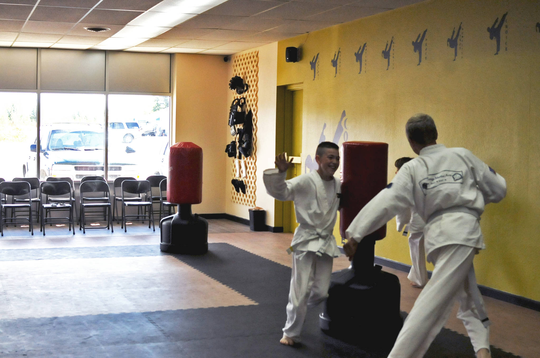 Students run off some energy before taekwondo class begins at Challenge Martial Arts Studio on Monday, Aug. 14, 2017 in Nikiski, Alaska. The studio, which opened in June, offers taekwondo and kickboxing classes in a renovated studio a few doors down from the M&M Supermarket on the Kenai Spur Highway. (Photo by Elizabeth Earl/Peninsula Clarion)