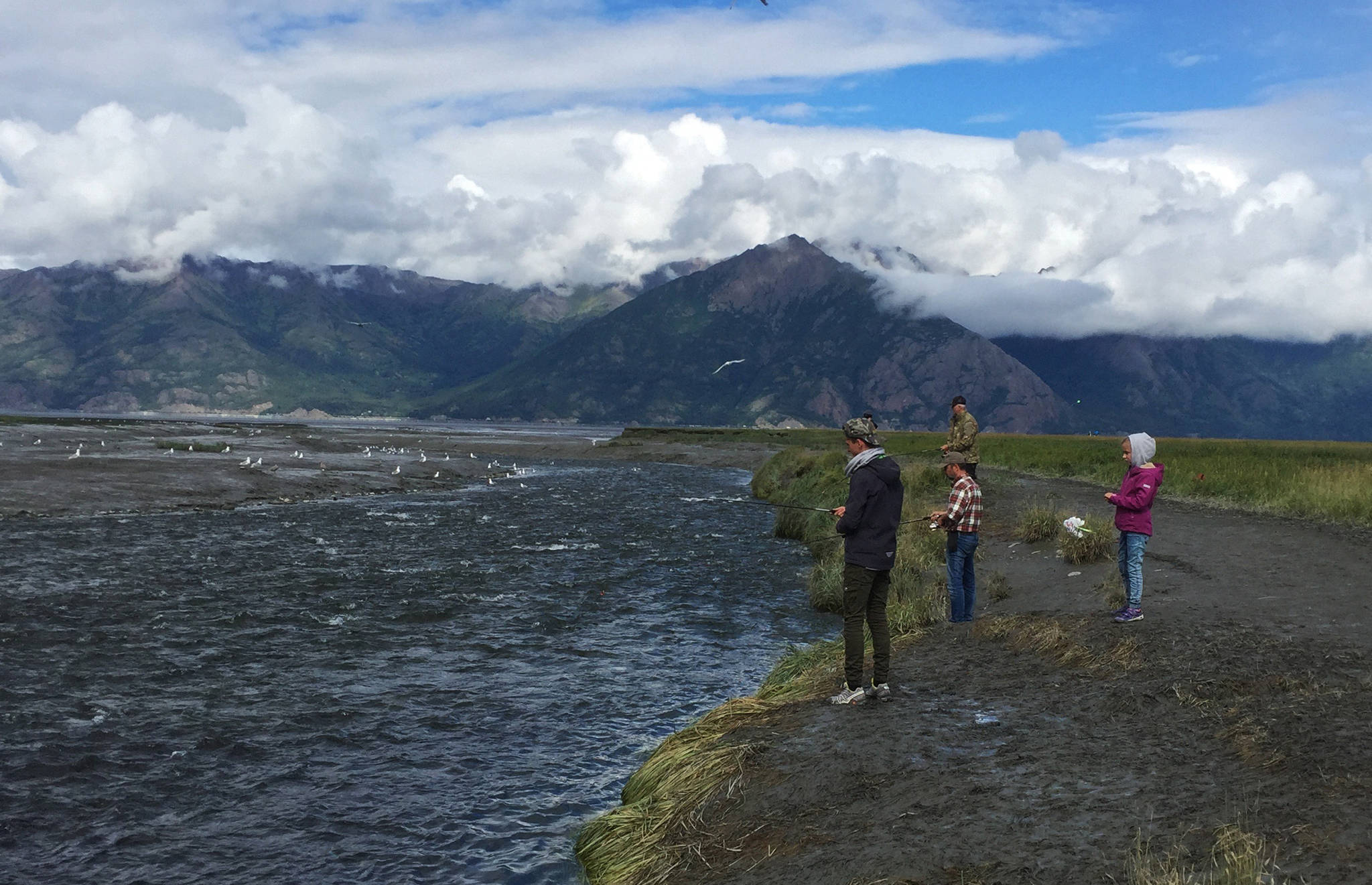 Anglers cast for pink and silver salmon from the banks of Resurrection Creek near its confluence with the Turnagain Arm of Cook Inlet on Sunday, Aug. 13, 2017 in Hope, Alaska. Pink salmon can return in large numbers to the creek in the late summer and early fall. (Photo by Elizabeth Earl/Peninsula Clarion)
