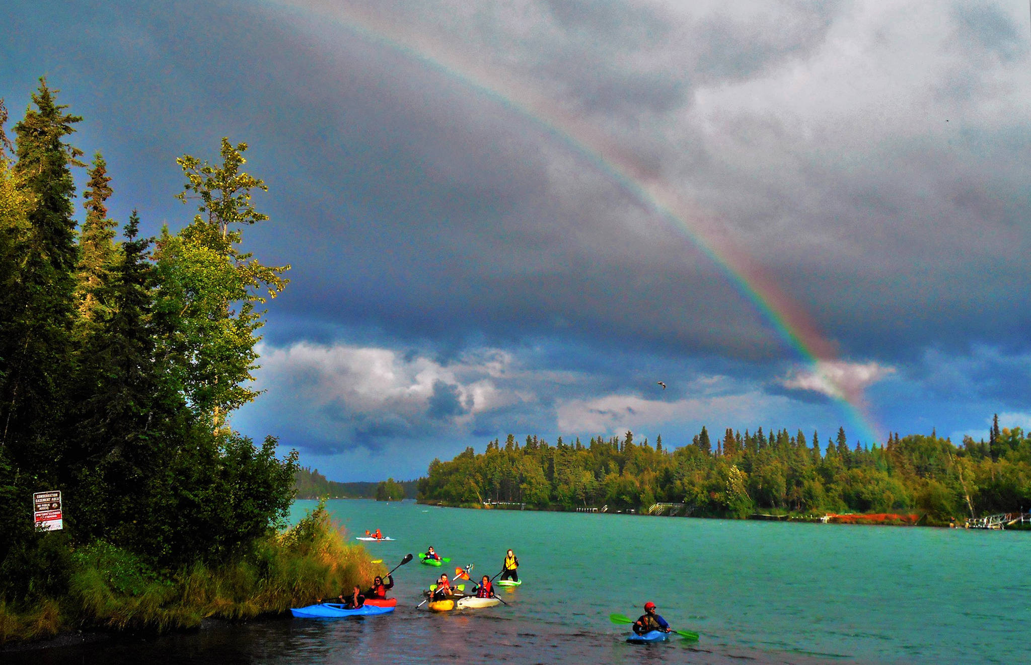 The arc of a clear rainbow with a faint second rainbow above it glows over the Kenai River as a group of kayakers pull into the mouth of Soldotna Creek on Wednesday, Aug. 16, 2017 in Soldotna, Alaska. Spotty rain showers in the central Kenai Peninsula area made for a wet day Wednesday, but the clouds parted enough in the evening to allow a little sunshine through to light up the Wednesday Market in Soldotna Creek Park. More clouds descended Thursday morning, though, with occasional spurts of rain predicted for Friday through Sunday with highs in the upper 50s and lows in the high 40s. (Photo courtesy Jennifer Lynn)