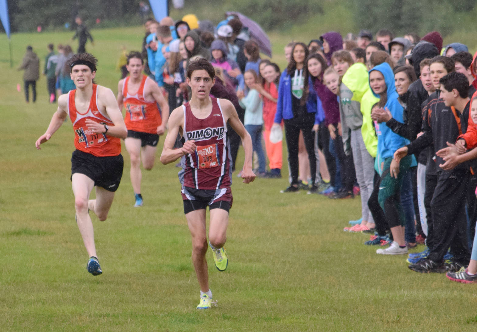 West’s Declan Dammeyer and Ethan Davis fail to catch Dimond’s Santiago Prosser in the final steps of the boys race Saturday, Aug. 19, 2017, at the Tsalteshi Invitational. (Photo by Jeff Helminiak/Peninsula Clarion)