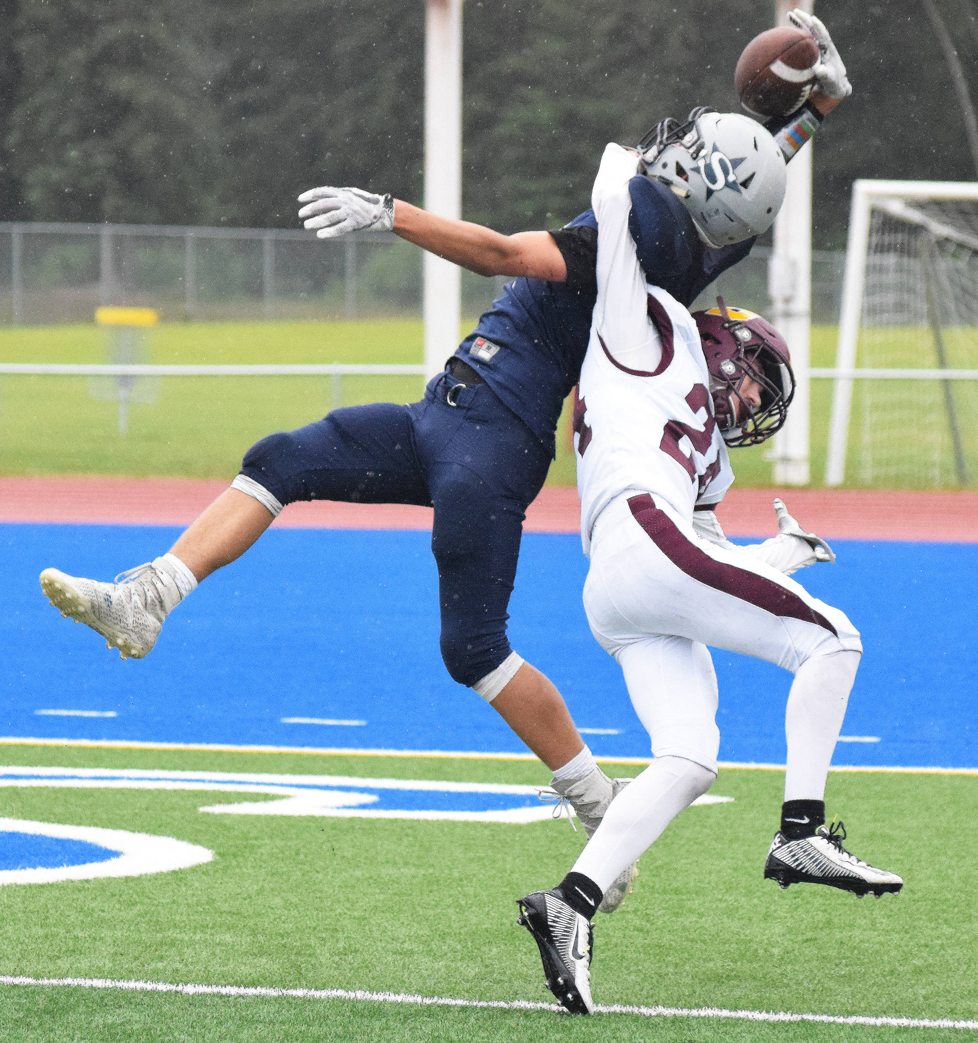 Soldotna cornerback Cy Updike nearly hauls in an interception above Dimond receiver R.J. Cavazos Friday night at Justin Maile Field in Soldotna. (Photo by Joey Klecka/Peninsula Clarion)