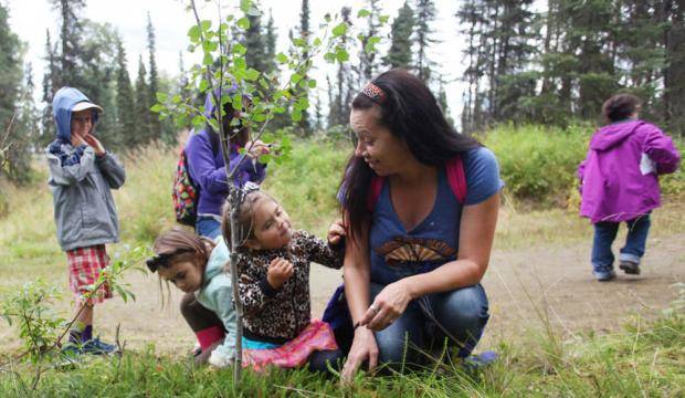 (Left to right) Kalista, Shaunzi and Kimbra Clements crouch in a patch of low bush cranberries Aug. 15, 2016 on Tsalteshi Trails’ Wolverine Trail in Soldotna, Alaska during the Harvest Moon Festival. (Clarion File Photo)
