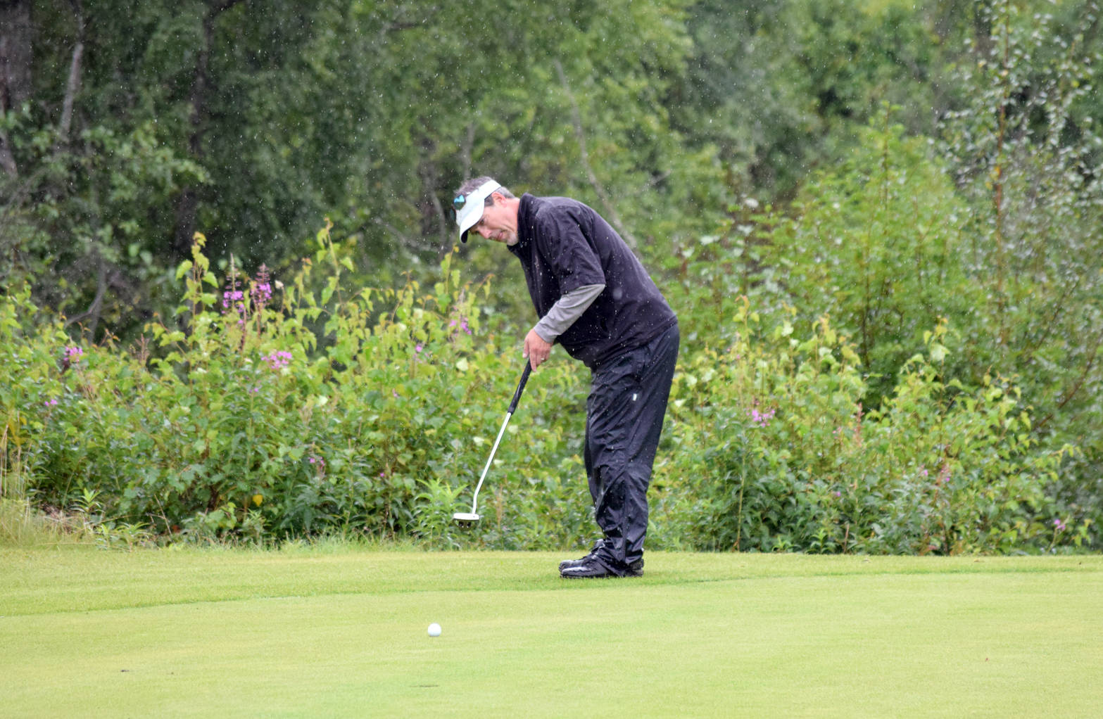 Chris Morin putts for birdie on the 18th green Sunday, Aug. 20, 2017, at the Kenai Golf Course during the Kenai Open. Morin’s putt came up short and the three-time defending champ lost by one stroke to Max Dye. (Photo by Jeff Helminiak/Peninsula Clarion)