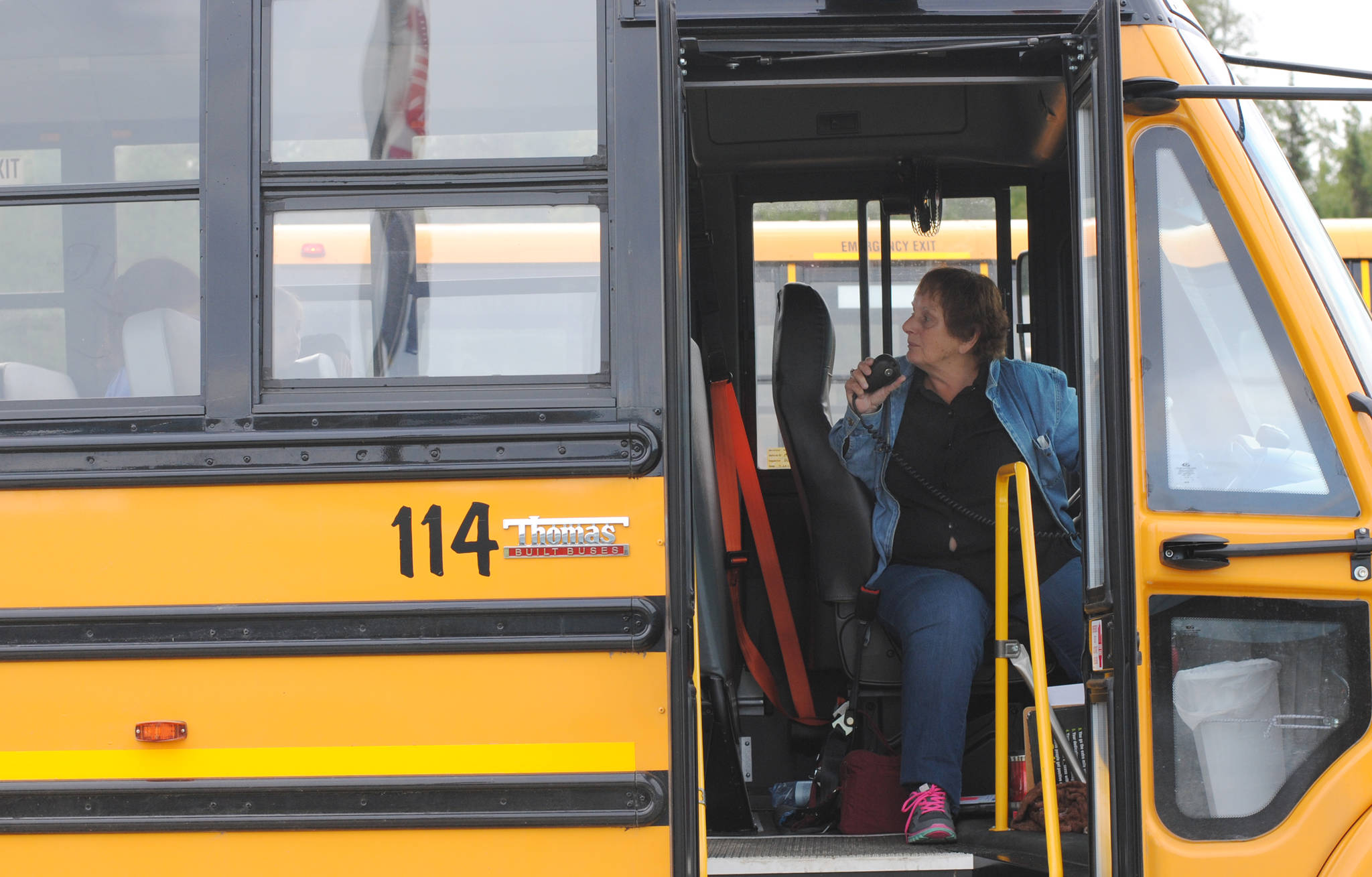 Colleen Puch wishes the students on her bus good luck on their first day of school at Nikiski North Star Elementary School, marking the start of her forty fourth year as a school bus driver Tuesday, Aug. 22, 2017 in Nikiski, Alaska. She chose to drive for one more year so she could drive her great-grandson to school, after having driven her children and grandchildren. (Photo by Kat Sorensen/Peninsula Clarion)