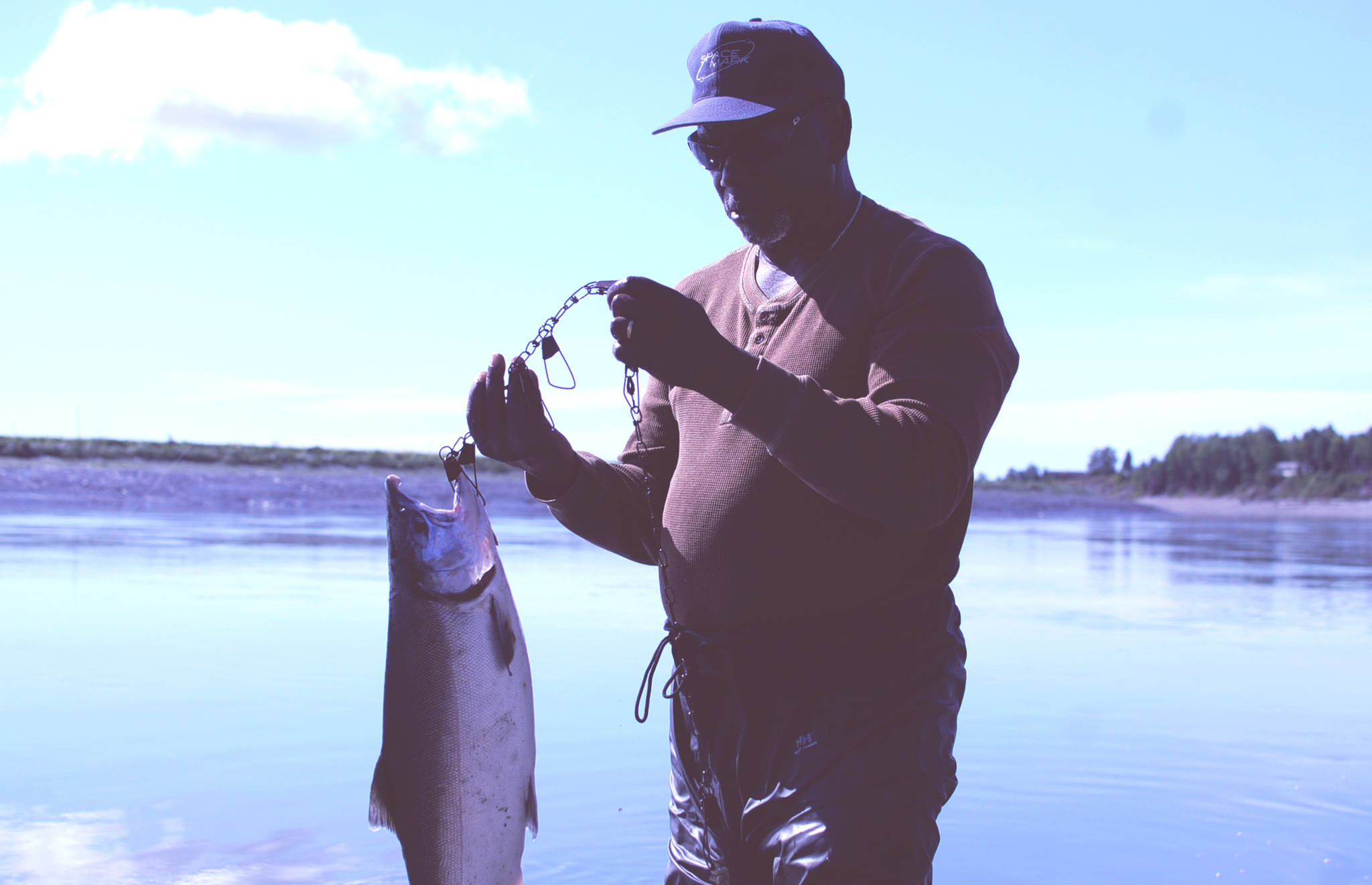 John Riggins of Kenai holds up the silver salmon he caught on the Kenai River in Cunningham Park on Tuesday, Aug. 22, 2017 in Kenai, Alaska. (Photo by Elizabeth Earl/Peninsula Clarion)