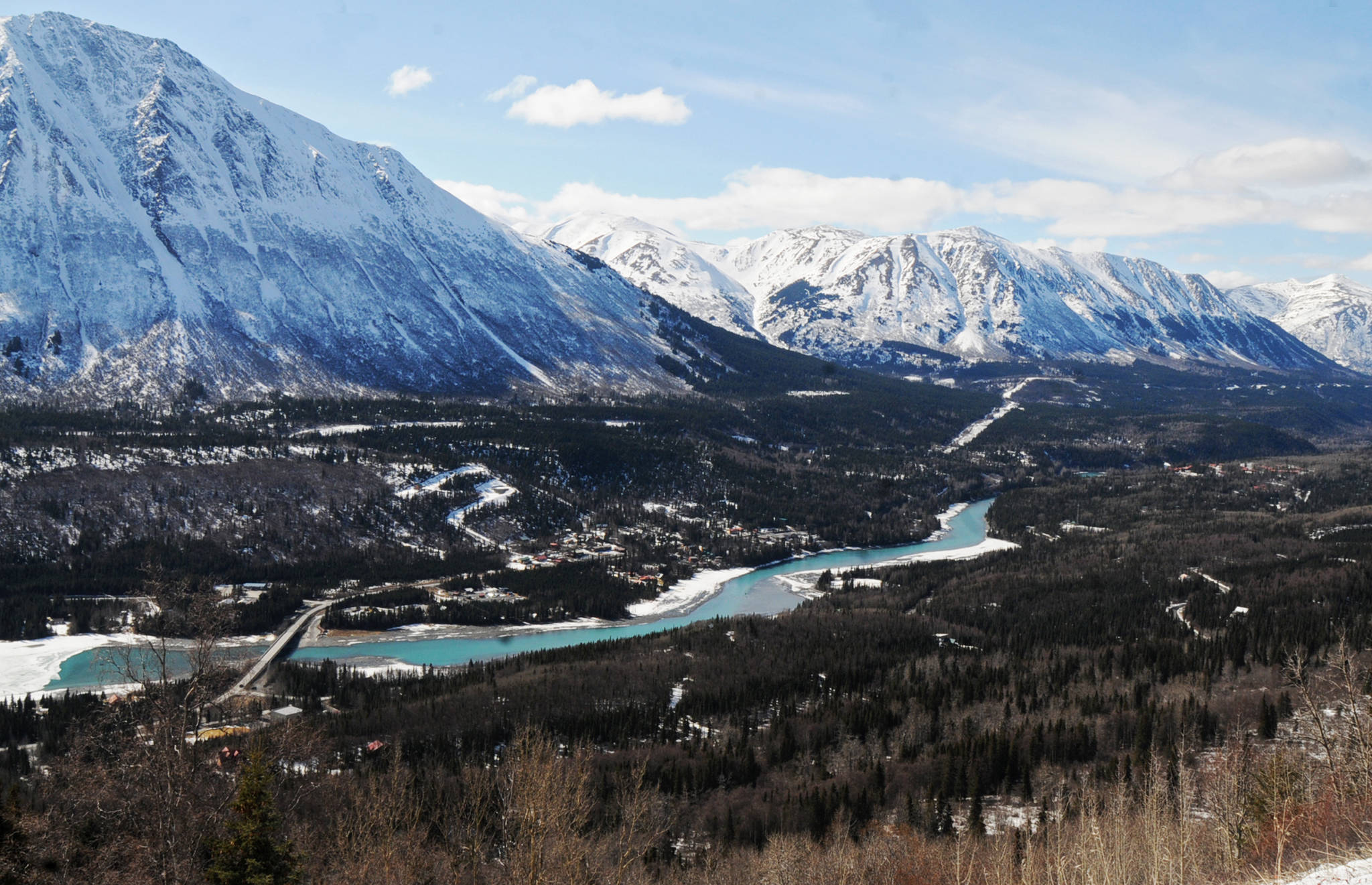 In this April 2017 photo, the Sterling Highway crosses the Kenai River and runs through the community of Cooper Landing, Alaska. The federal and state departments of transportation have been looking at rerouting the highway since the 1970s to avoid the town of Cooper Landing, where traffic must slow down to 35 miles per hour and run through an area that becomes congested in the summer. (Photo by Elizabeth Earl/Peninsula Clarion)