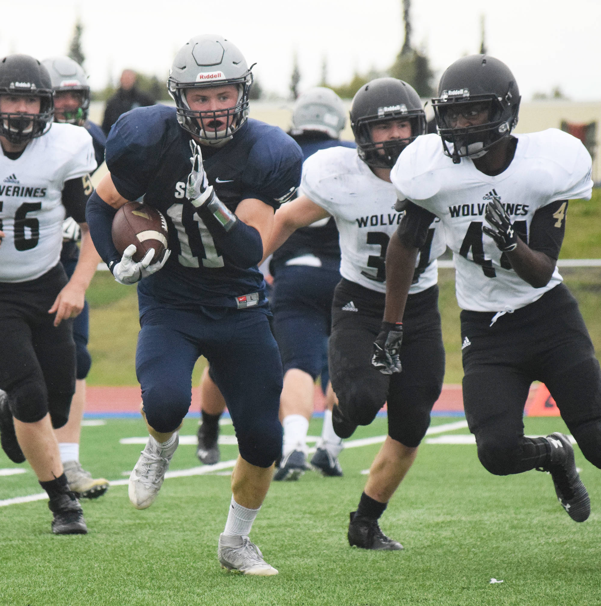 Soldotna running back Brenner Furlong evades a bevy of South Anchorage defenders Friday night at Justin Maile Field in Soldotna. (Photo by Joey Klecka/Peninsula Clarion)