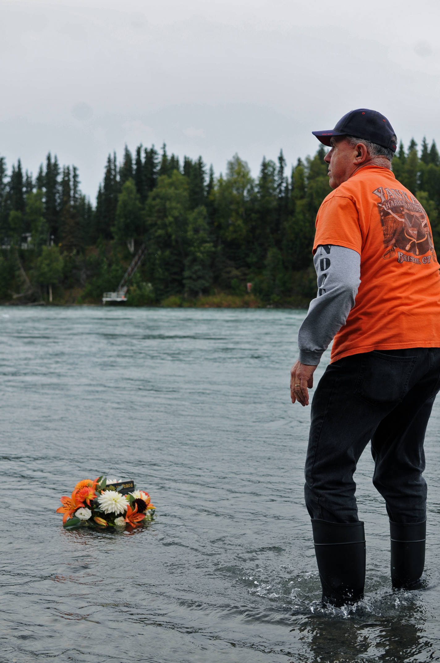 Paul Montenieri, the founder of the Soldotna senior softball league, releases a wreath in honor of Kurt Keltner on the Kenai River on Tuesday, Aug. 29, 2017 in Soldotna, Alaska. Keltner, who lived in Sterling during the summers and Colorado in the winters, has been missing since Aug. 4, when he was thrown from a fishing boat due to a mechanical error near Centennial Park and was not able to swim to shore. (Photo by Elizabeth Earl/Peninsula Clarion)