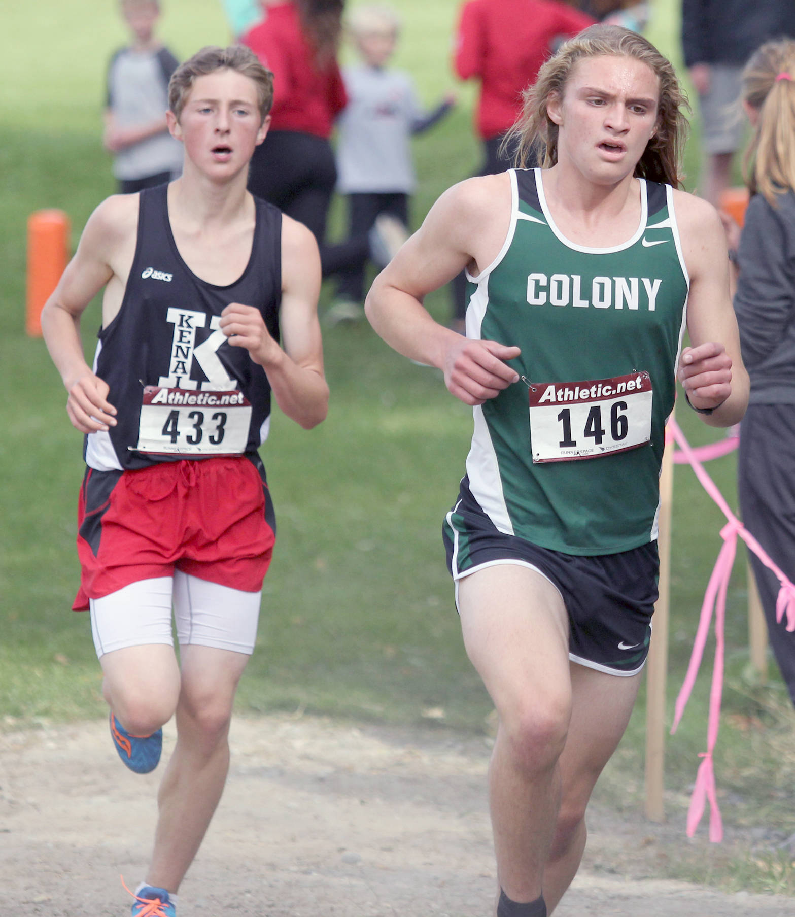 Colony’s Gavin Block runs just ahead of Kenai Central’s Maison Dunham during the boys varsity race of the Palmer Invitational on Saturday, Sept. 2, 2017, at Palmer High School. Dunham finished seventh and Block was 10th. (Photo by Jeremiah Bartz/Frontiersman)