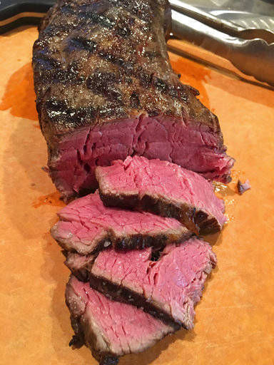 This July 25 photo shows a beef tenderloin that was given a gentle sous vide cooking before being seared on a grill in Houston, Texas, from a recipe for “The Ultimate Reverse Sear” by Elizabeth Karmel. Reverse-sear is a technique where you cook the meat slowly using a low indirect heat and when it is almost done, you sear it over a high direct heat to brown the outside. (Elizabeth Karmel via AP)
