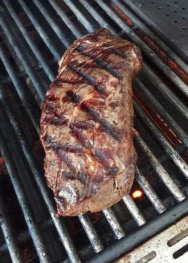 This July 25 photo shows a beef tenderloin that was given a gentle sous vide cooking before being seared on a grill in Houston, Texas, from a recipe for “The Ultimate Reverse Sear” by Elizabeth Karmel. Reverse-sear is a technique where you cook the meat slowly using a low indirect heat and when it is almost done, you sear it over a high direct heat to brown the outside. (Elizabeth Karmel via AP)
