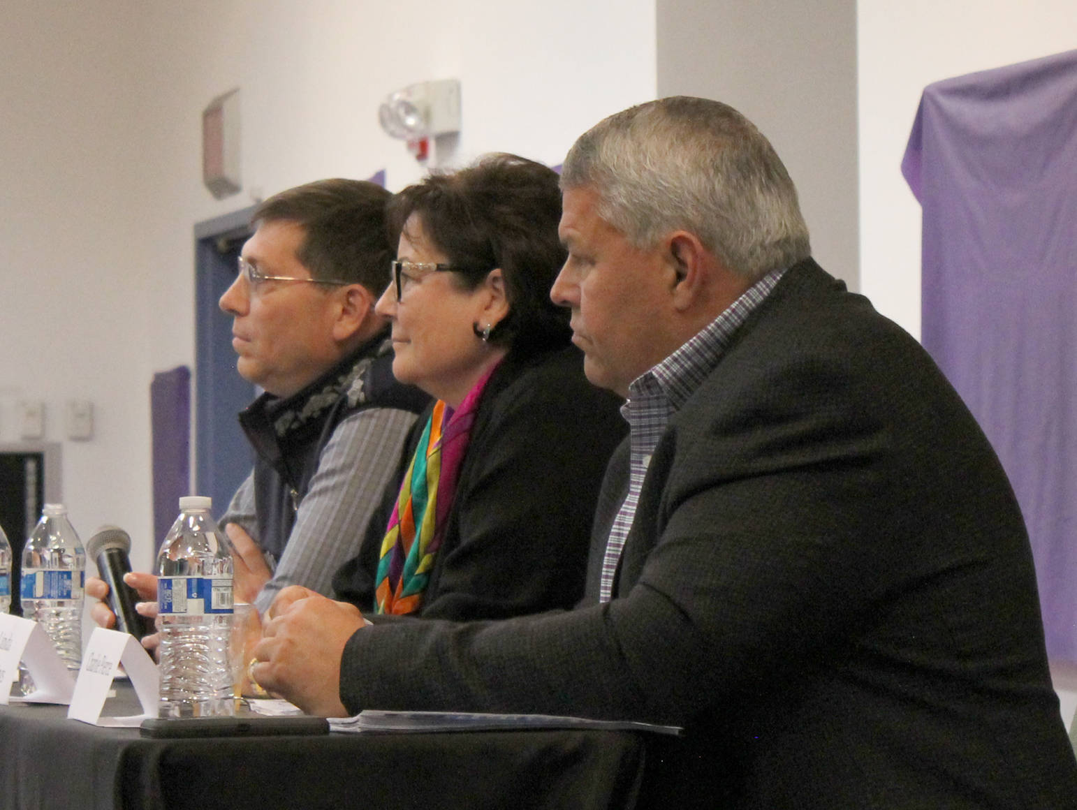 Dale Bagley, Linda Hutchings and Charlie Pierce listen to a question during a forum for borough mayoral candidates Wednesday at a joint meeting of the Kenai and Soldotna Chambers of Commerce at the Kenai Visitors Center. (Photo by Will Morrow/Peninsula Clarion)