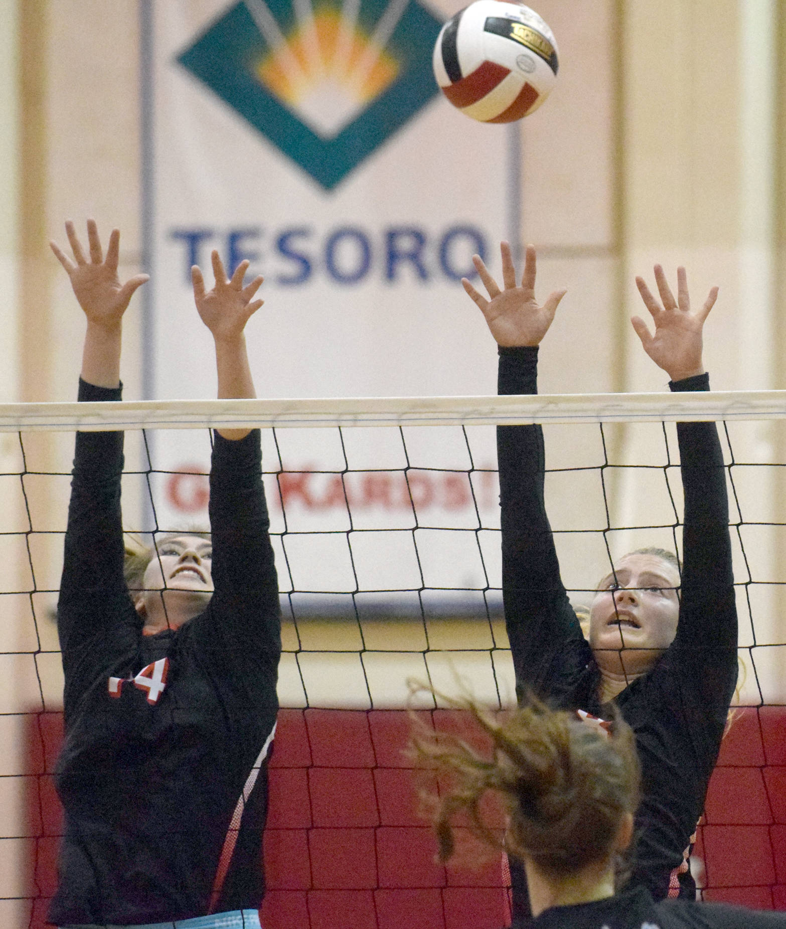 Kenai Central’s Sam Kompkoff and Mayzie Potton put up a block against Palmer on Wednesday, Sept. 6, 2017, at Kenai Central High School. (Photo by Jeff Helminiak/Peninsula Clarion)