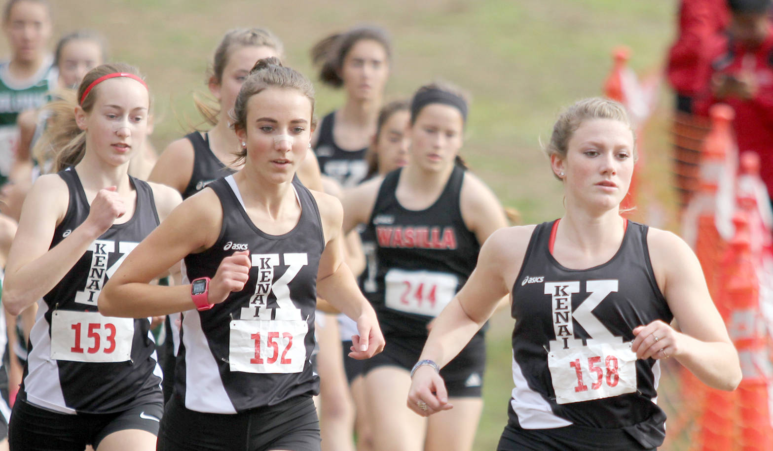 Kenai Central senior Addison Gibson leads a trio of Kards early in the varsity girls’ race of the Wasilla Invitational Saturday, Sept. 9, 2017, at the Government Peak Recreation Area near Palmer. Gibson finished second. From left are Jaycie Calvert, Brooke Satathite and Riana Boonstra. (Photo by Jeremiah Bartz/Frontiersman)