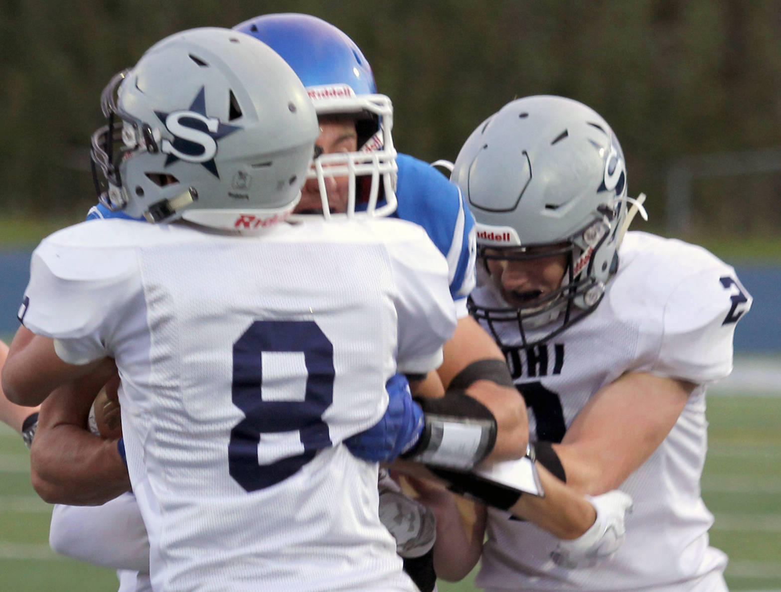 Soldotna’s Cy Updike and Cody Quelland work to bring down Palmer running back Larry Cutsforth during a 28-10 win over the Moose on Friday, Sept. 8, 2017, at Palmer High School. (Photo by Tim Rockey/For the Frontiersman)