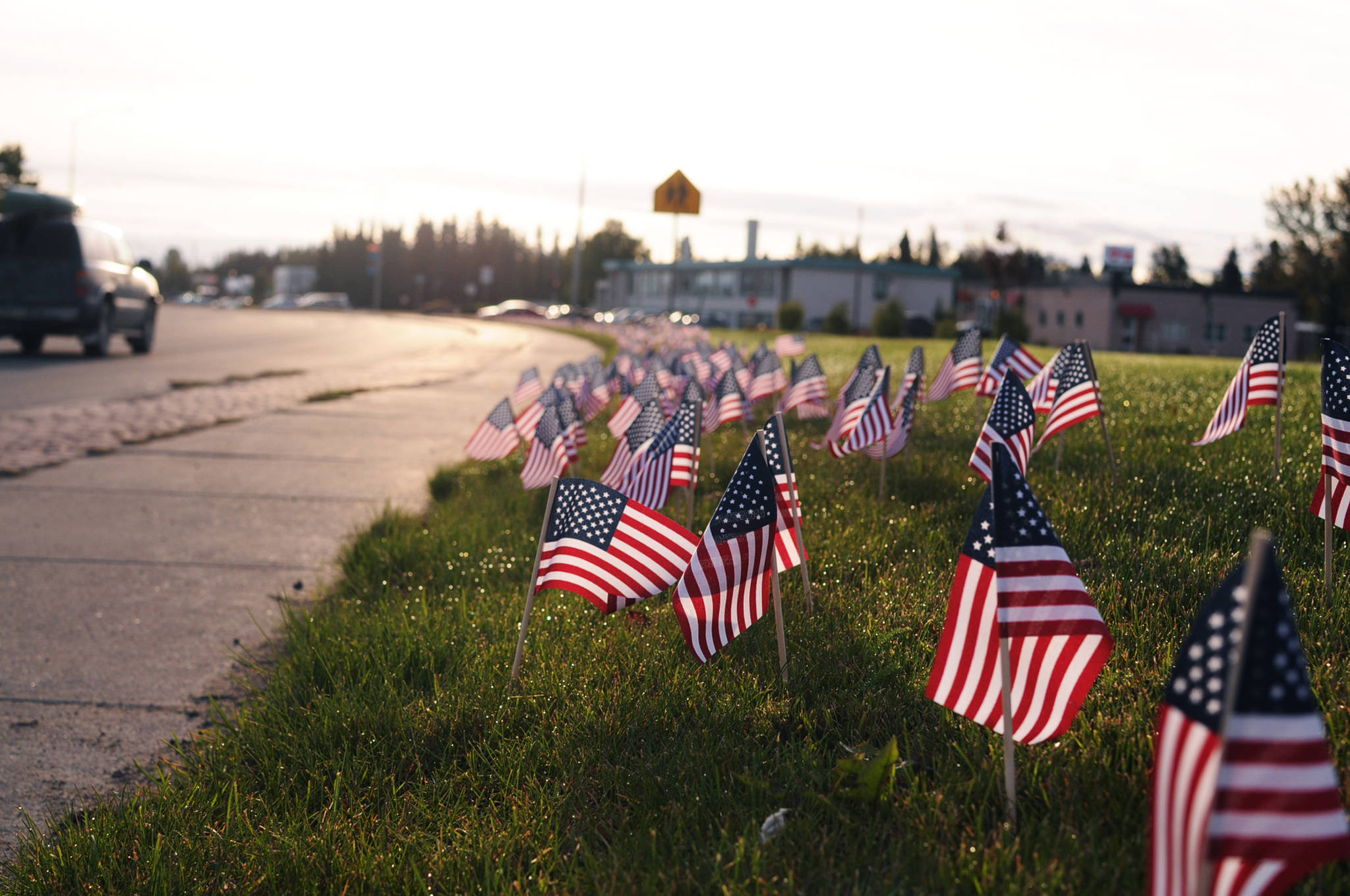 Not forgotten Small American flags dot the lawn alongside the Kenai Spur Highway on Monday in Kenai. The American Legion post in Kenai placed 2,996 flags on the greenway between Frontage Road and the highway, one for each person killed in coordinated terrorist attacks on the morning of Sept. 11, 2001. The display added to the Kenai Fire Department’s display of 343 flags on the corner of Willow and Main streets in honor of the firefighters killed in the line of duty trying to rescue people from the burning World Trade Center towers. (Photo by Elizabeth Earl/Peninsula Clarion)