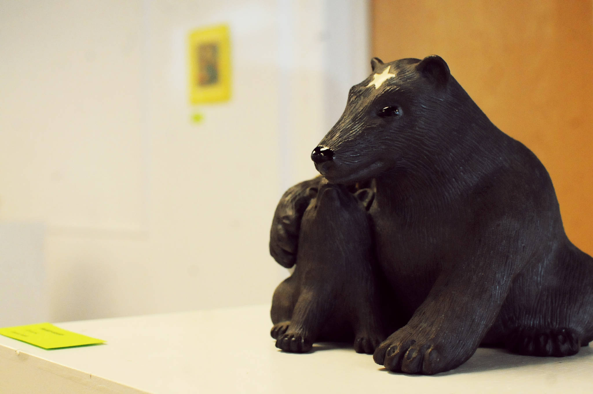 A ceramic bear sculpture by potter Laura Faeo rests atop a pedestal in the Kenai Fine Art Center on Thursday, Sept. 7, 2017 in Kenai, Alaska. The sculpture, along with a number of other paintings, sculptures, photographs and other art works, will be available for purchase either through silent bidding or outcry auction at the center’s annual Harvest Art Auction, scheduled for Sept. 30 at 6 p.m. Silent bidding began Thursday and will run until the event on Sept. 30, when the outcry auction will take place. The funds go to support the art center’s activities throughout the year. Tickets for the event are $30 and include appetizers, desserts, music and door prizes. (Photo by Elizabeth Earl/Peninsula Clarion)