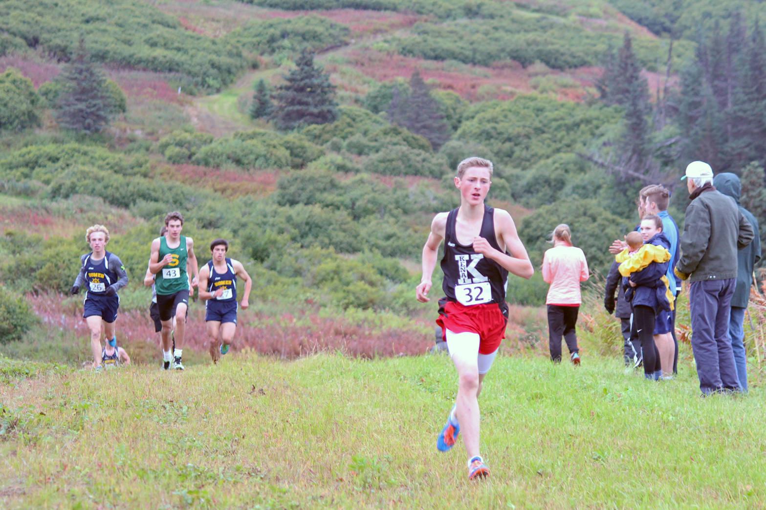 Kenai Central High School runner Maison Dunham pulls ahead of the pack nearing the end of the varisy boys race at the Kenai Peninsula Borough Cross-Country Running Championships on Tuesday, Sept. 12, 2017 at the Lookout Mountain Trails near Homer, Alaska. Soldotna High School took first overall out of the varsity boys teams, and the Kenai team claimed the top spot for the girls. (Photo by Megan Pacer/Homer News)