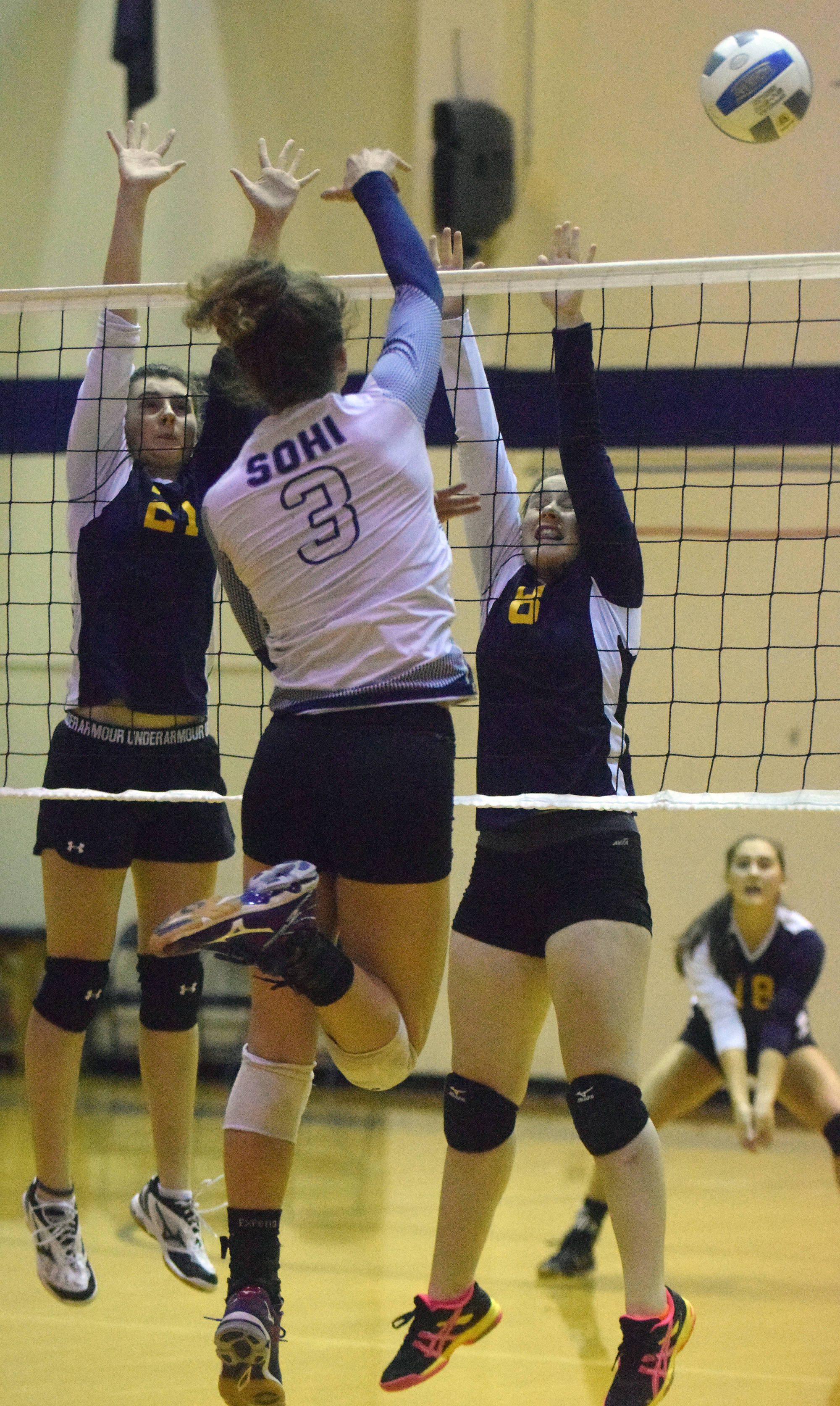 Homer sophomores Marina Caroll (21) and Kitri Classen (8) block a shot by Soldotna senior Ella Stenga Tuesday night at Soldotna High School. (Photo by Joey Klecka/Peninsula Clarion)