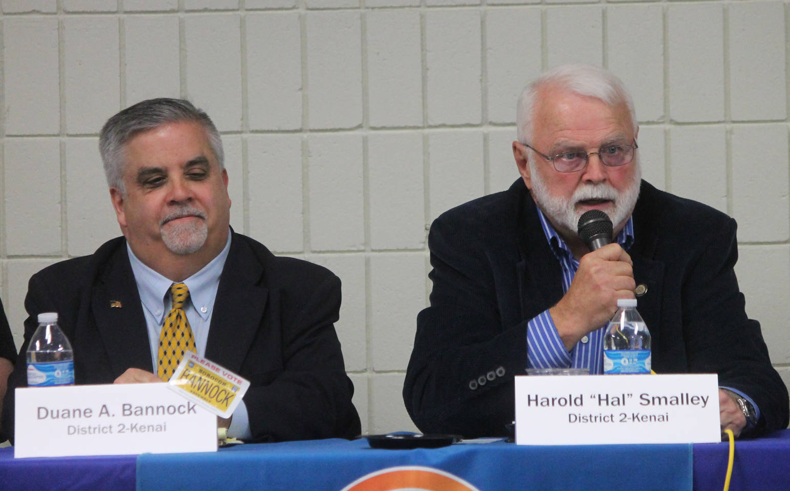 Duane Bannock, left, listens while Hal Smalley answers a question during a forum for Kenai Peninsula Borough Assembly candidates Wednesday at a joint meeting of the Kenai and Soldotna Chambers of Commerce. Bannock and Smalley are running for the District 2-Kenai seat. (Photo by Will Morrow/Peninsula Clarion)
