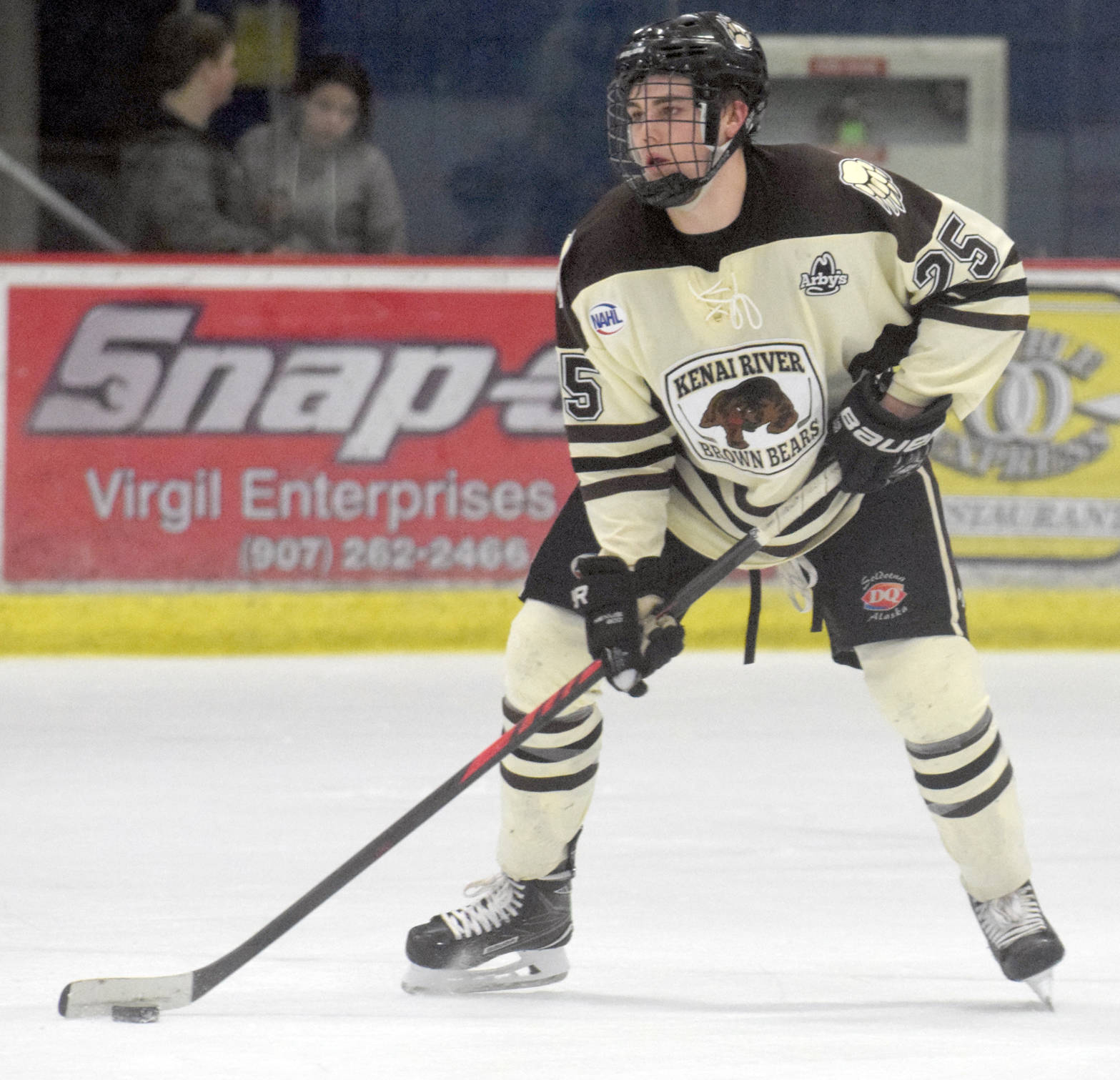 Kenai River Brown Bears defenseman Preston Weeks controls the puck last season at the Soldotna Regional Sports Complex. Weeks has been named captain of this year’s team. (Photo by Jeff Helminiak/Peninsula Clarion)