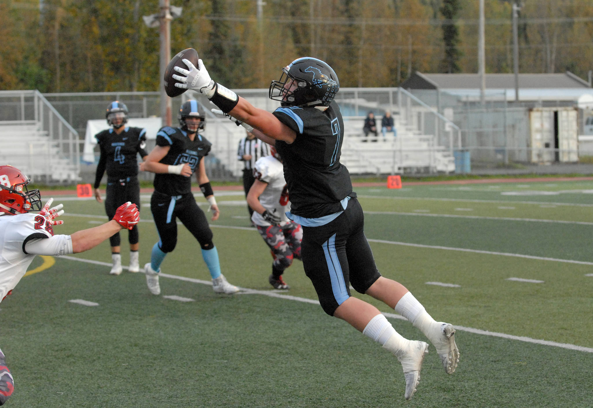 Chugiak’s Derryk Snell leaps to catch a pass during Chugiak’s 48-0 nonconference high school football win over Kenai on Friday, Sept. 15, 2017 at Tom Huffer Sr. Stadium in Chugiak. (Star photo by Matt Tunseth)