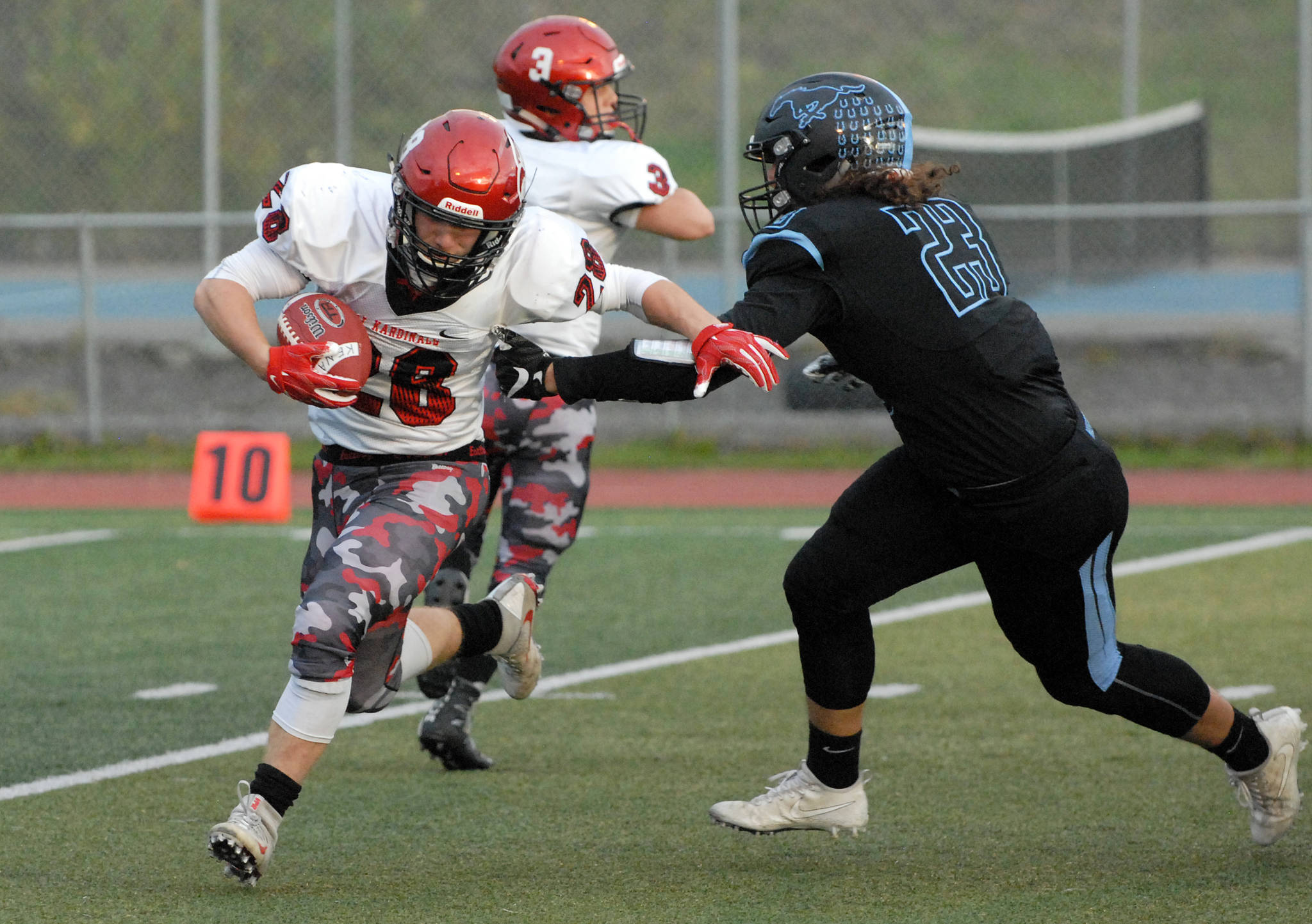 Kenai Central’s Ryker Riddall is tackled by Chugiak’s Ty Carlos during Chugiak’s 48-0 nonconference high school football win over Kenai on Friday, Sept. 15, 2017 at Tom Huffer Sr. Stadium in Chugiak. (Star photo by Matt Tunseth)