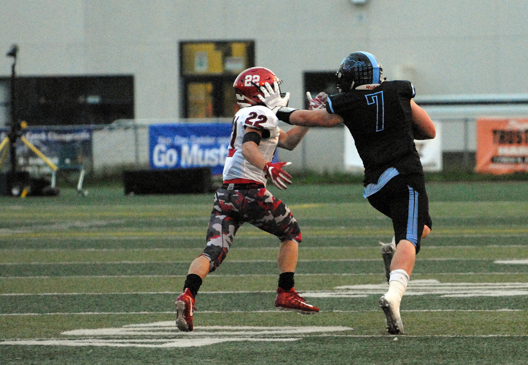 Chugiak’s Derryk Snell stiffarms Kenai Central’s Titus Riddall during Chugiak’s 48-0 nonconference high school football win over Kenai on Friday, Sept. 15, 2017 at Tom Huffer Sr. Stadium in Chugiak. (Star photo by Matt Tunseth)