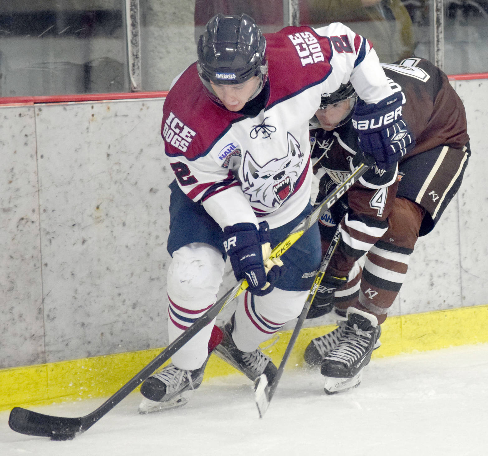 Fairbanks forward Brady Dahl tries to escape from Kenai River forward Sacha Guillemain on Friday, Sept. 15, 2017, in a scrimmage at the Kenai Multi-Purpose Facility in Kenai. (Photo by Jeff Helminiak/Peninsula Clarion)