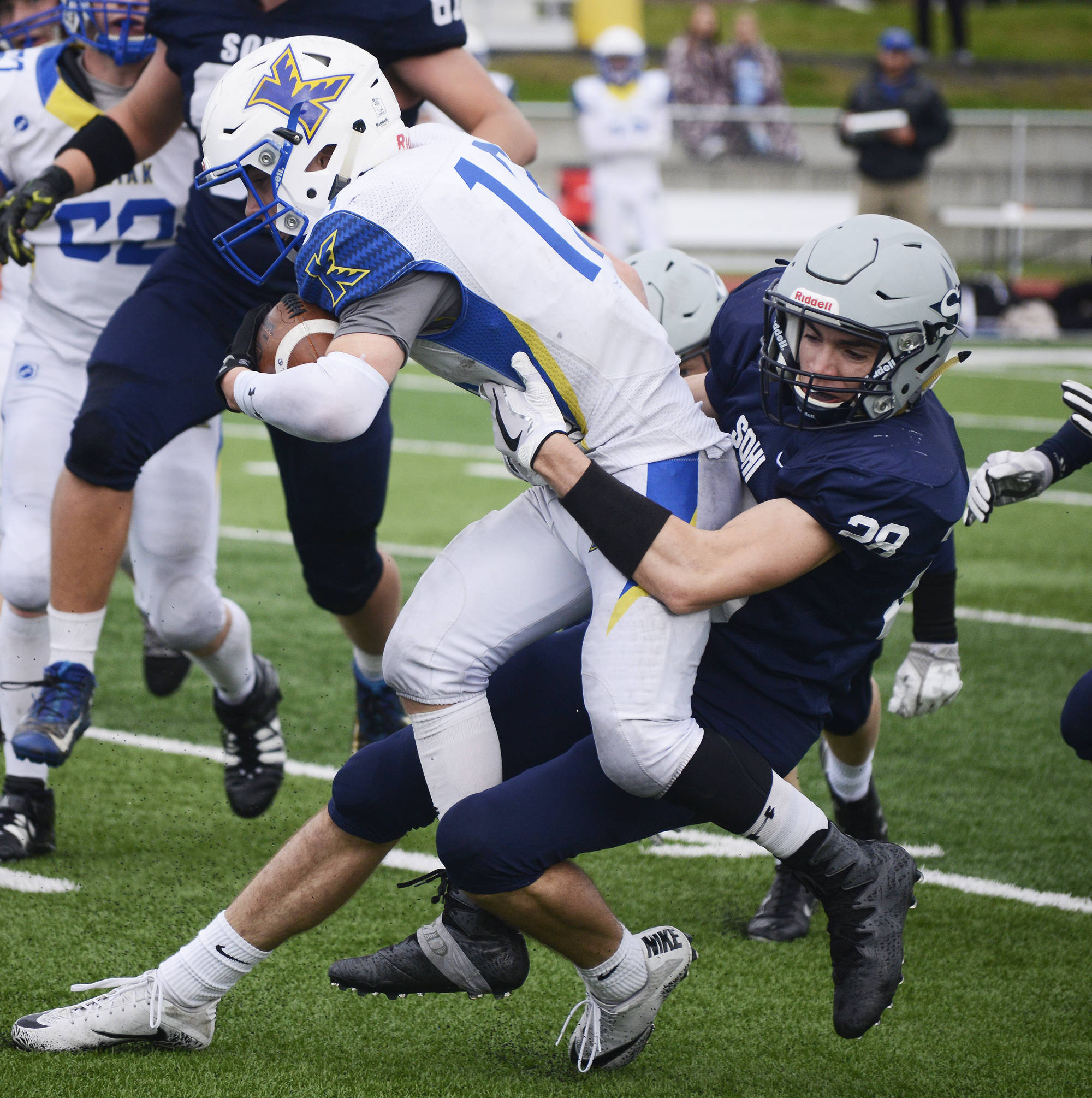 Soldotna defensive back Sam McElroy wraps up Kodiak running back Kaleb Finley Saturday at Justin Maile Field in Soldotna. (Photo by Joey Klecka/Peninsula Clarion)