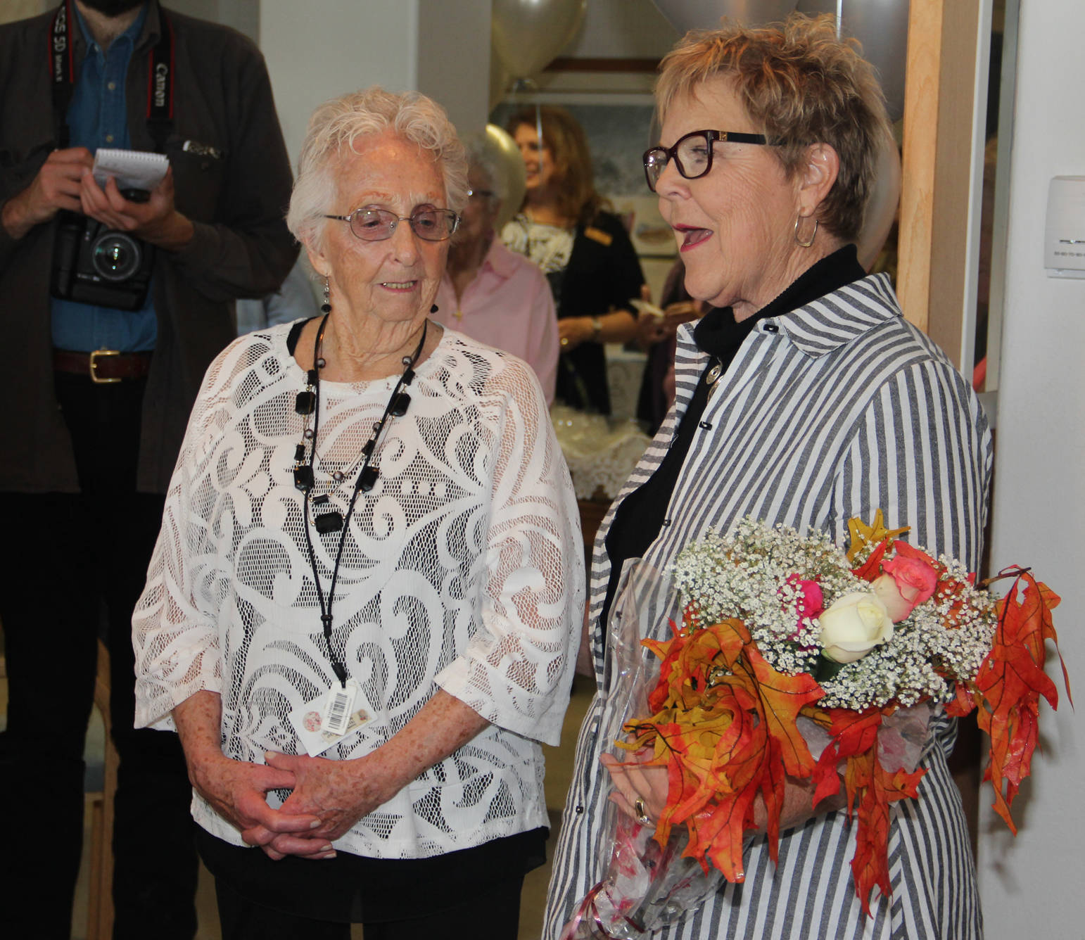 Pat Porter congratulates JoAnne Hollier, one of the first Vintage Pointe residents.