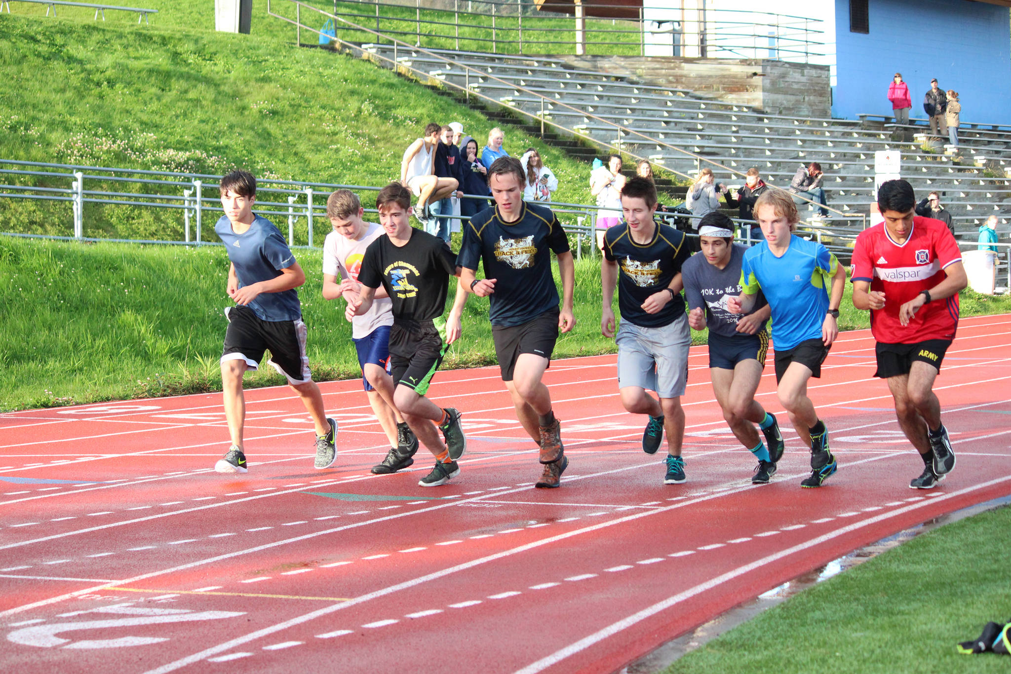 A group of male runners takes off from the starting line of the Mariner Mile, a new event held Thursday, Sept. 14, 2017 at the Homer High School running track in Homer, Alaska. The event, in which people could sign up to run one mile around the track in different heats, was a fundraiser for the Kachemak Bay Running Club. (Photo by Megan Pacer/Homer News)