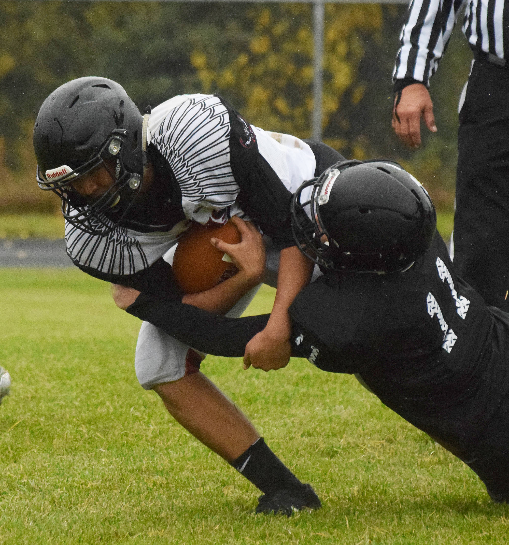 Eielson junior Jaydenn Manibusan attempts to shed Nikiski tackler Tyler Olson Friday evening at Nikiski High School. (Photo by Joey Klecka/Peninsula Clarion)