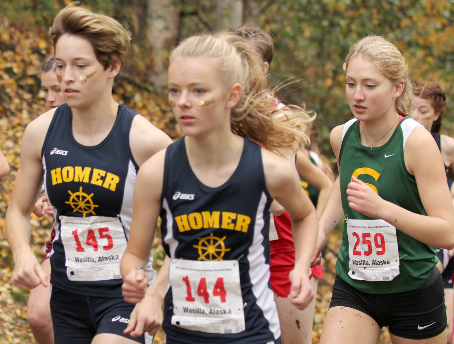 Homer’s Alex Moseley and Brooke Miller and Seward’s Ruby LIndquist jockey for position in the Division II girls race at the Region III Championshps on Saturday, Sept. 23, 2017, at the Government Peak Recreation Area. (Photo by Jeremiah Bartz/Frontiersman)