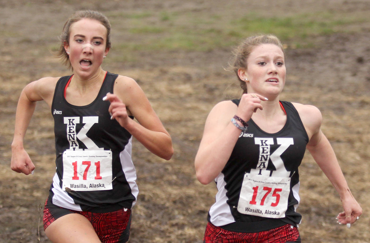 Kenai Central’s Riana Boonstra follows right behind teammate Addison Gibson during the final meters of the Division I girls’ race of the Region III Championships Saturday, Sept. 23, 2017, at the Government Peak Recreation Area near Palmer. Gibson held on to win the region title. Kenai also won the girls’ team title.