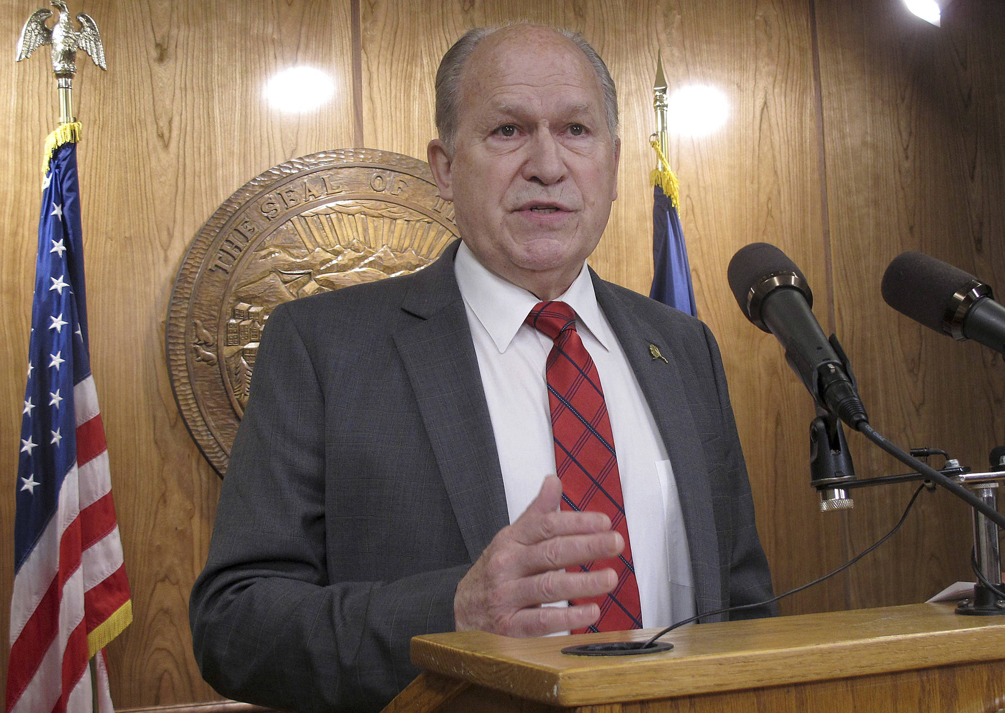 FILE - In this June 16, 2017, file photo Alaska Gov. Bill Walker speaks to reporters after calling a second special legislative session in Juneau, Alaska. Walker limited the session agenda to the state operating budget. Gov. Walker will propose a head tax on Alaskans to partially fill the multi-billion dollar gap between state revenue and spending. The governor, an independent, at special legislative session next month will propose a 1.5 percent flat tax on wages or self-employment income. (AP Photo/Becky Bohrer, File)