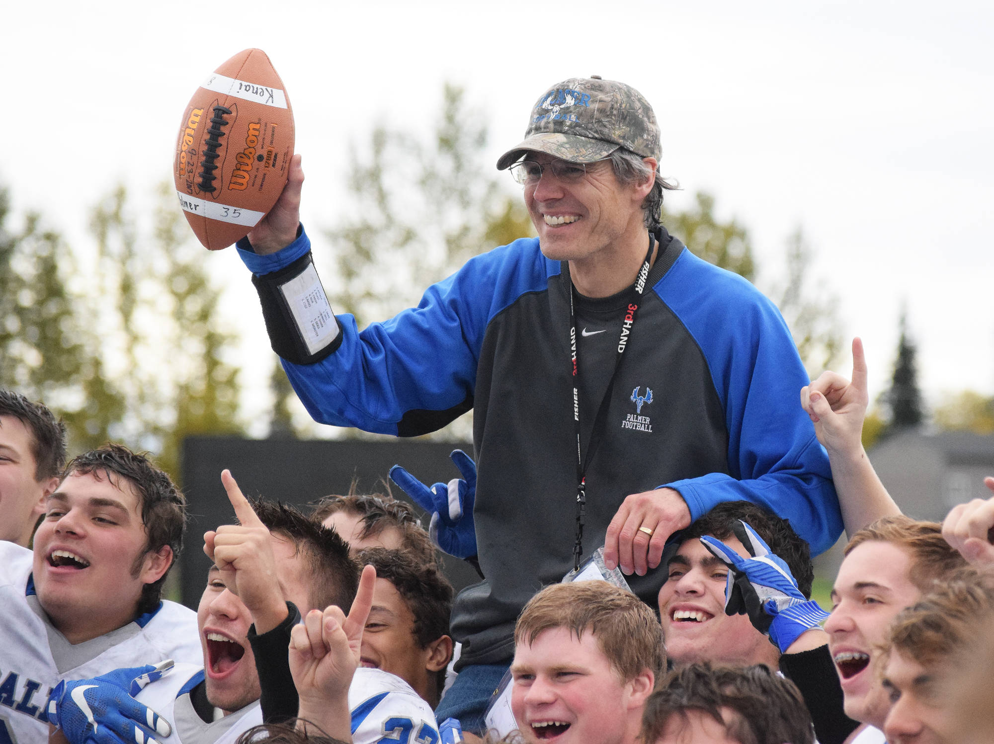 Palmer football coach Rod Christianson celebrates his 151st career coaching win with the Moose, Saturday at Ed Hollier field in Kenai. The milestone victory placed Christianson atop the all-time Alaska football coaching win list. (Photo by Joey Klecka/Peninsula Clarion)