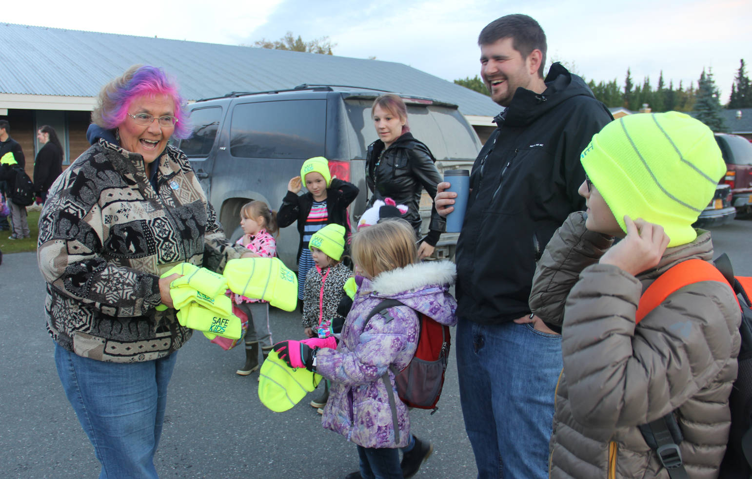 Event organizer Sharon Hale hands out Safe Kids easy to be seen hats on Walk to School day.