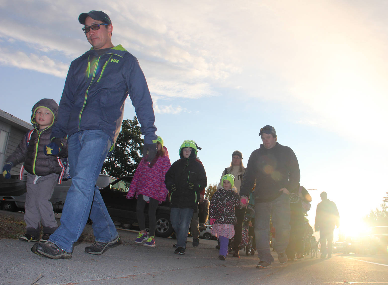 As the sun rises, students and their parents walk to school along Redoubt Avenue in Soldotna.
