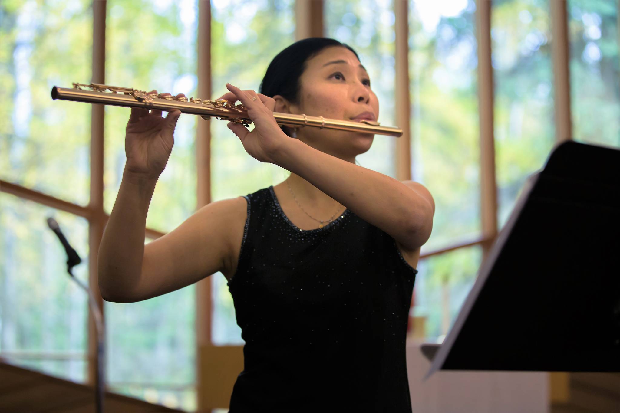 Tomoka Raften, who will be participating in the upcoming Evening of Classics on Oct. 6 with the Kenai Peninsula Orchestra performs the flute at a recent orchestra event. (Photo courtesy of Debbie Boyle)
