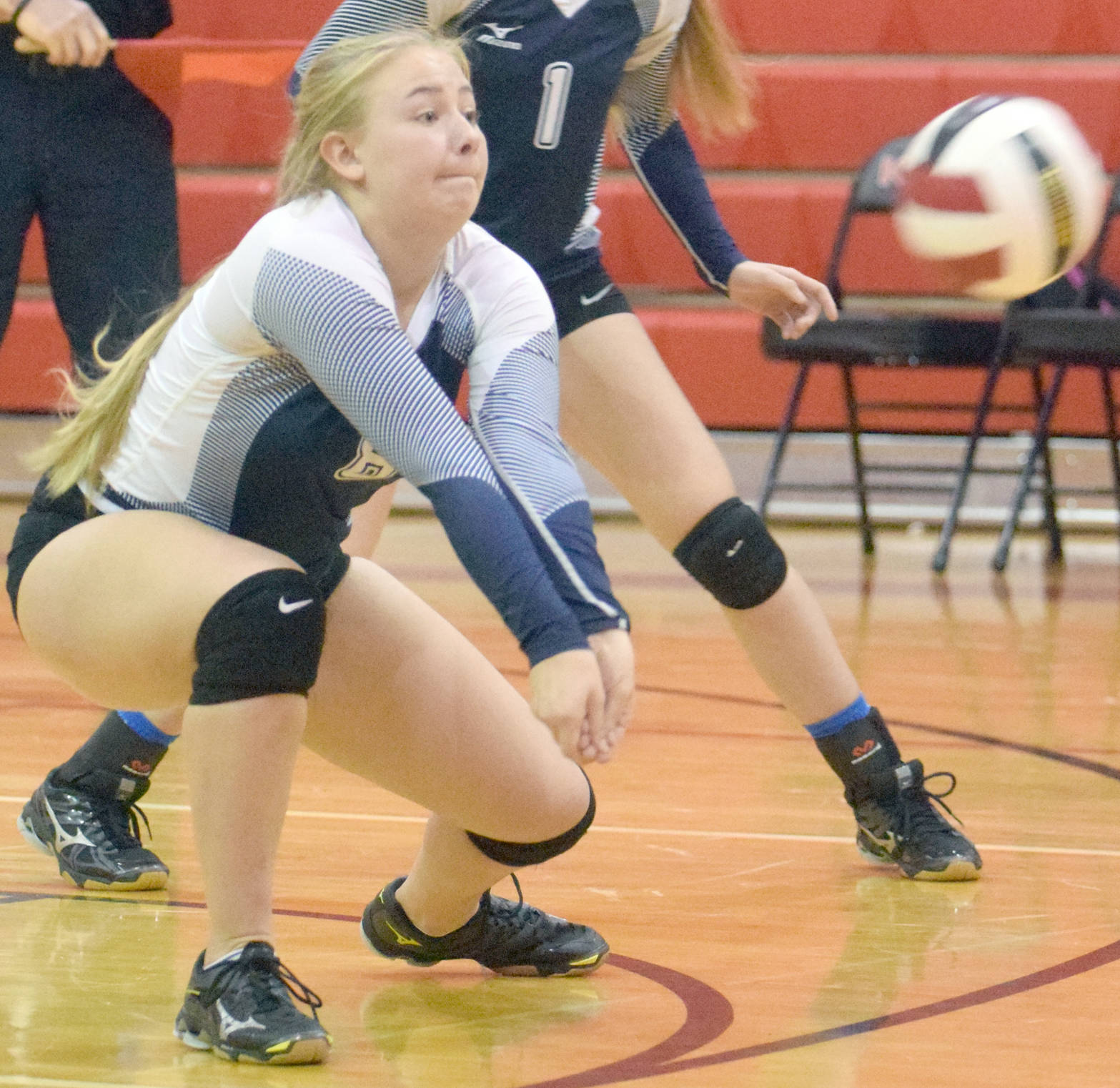 Brittani Blossom digs up a ball for Soldotna on Friday, Sept. 29, 2017, at Kenai Central High School. (Photo by Jeff Helminiak/Peninsula Clarion)