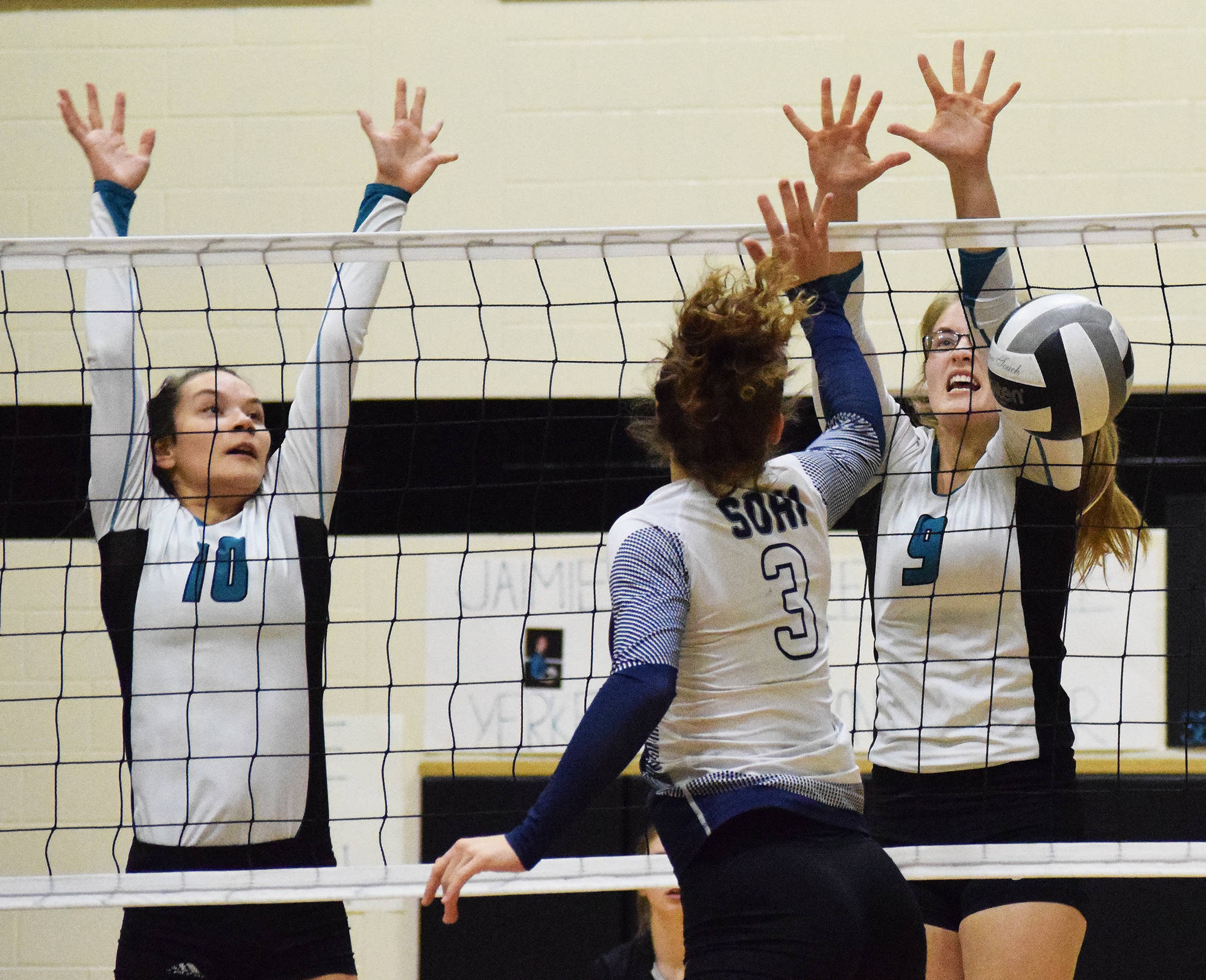 Nikiski duo Rylee Jackson (10) and Jamie Yerkes (9) block a shot from Soldotna’s Ella Stenga, Tuesday at Nikiski High School. (Photo by Joey Klecka/Peninsula Clarion)