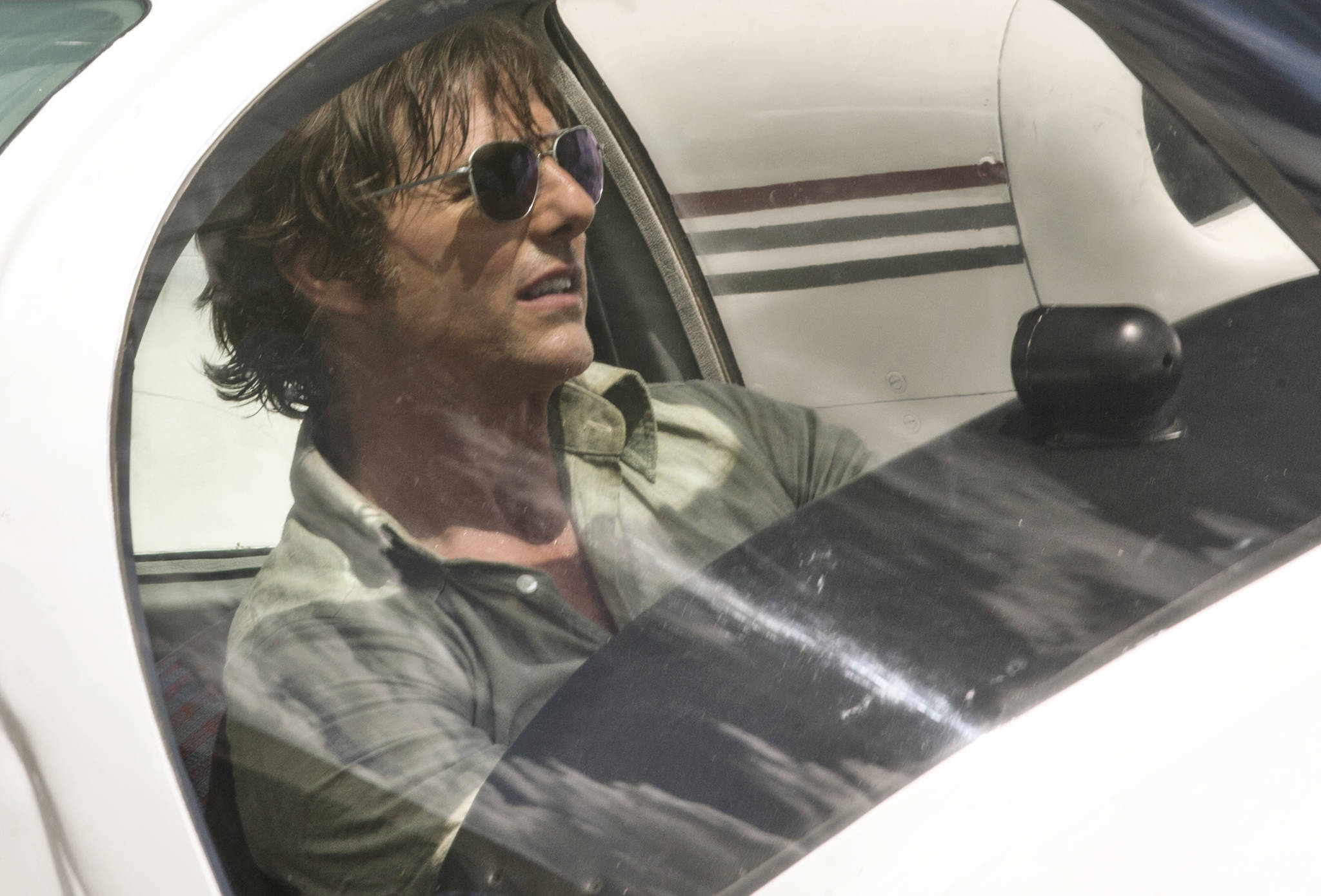 This image released by Universal Pictures shows Tom Cruise as Barry Seal in a scene from, “American Made.” (David James/Universal Pictures via AP)