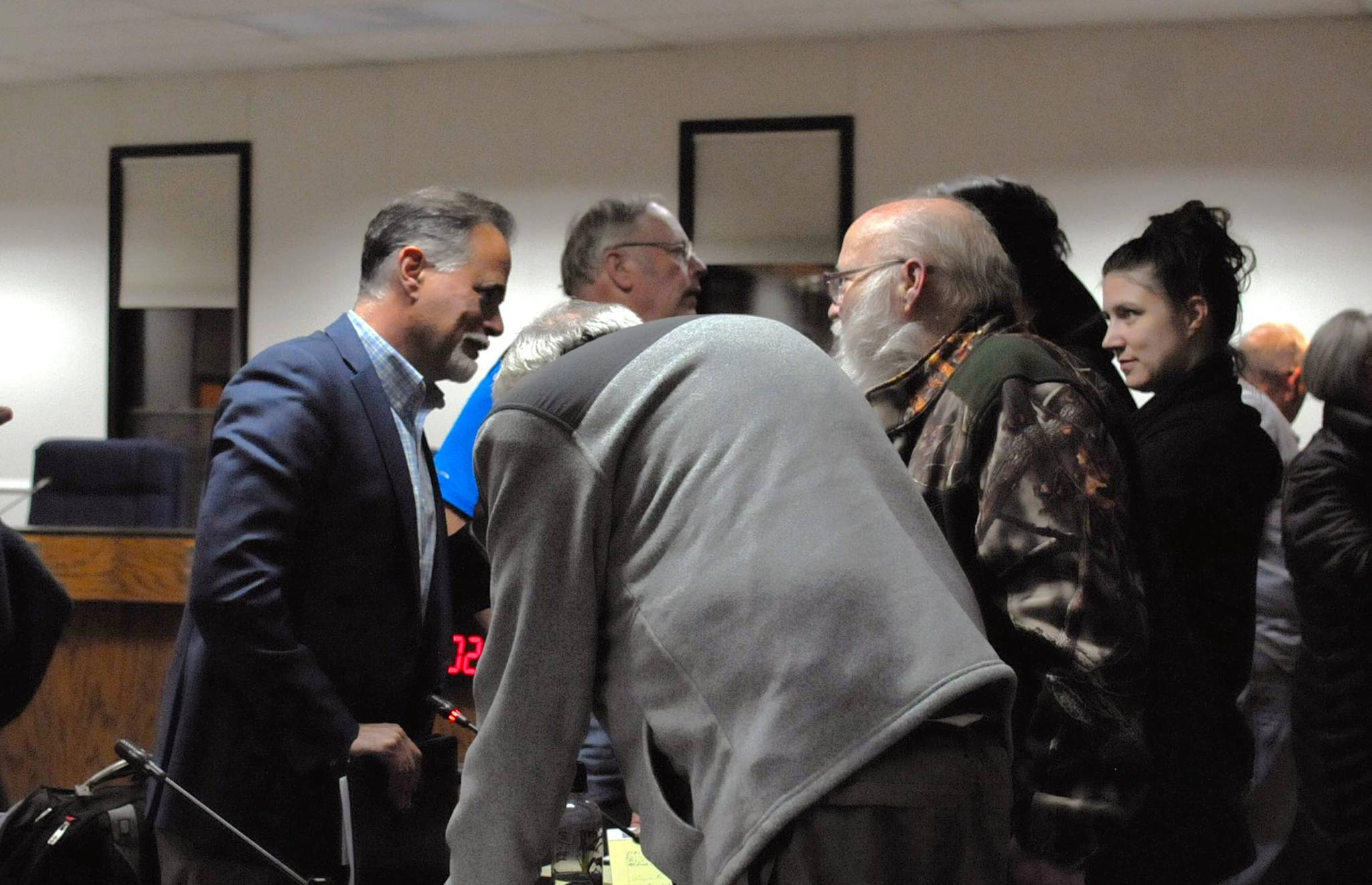 Sen. Peter Micciche (left), R-Soldotna, speaks to constituents after a town hall meeting with Rep. Gary Knopp, R-Kenai, and Rep. Mike Chenault, R-Nikiski, on Wednesday, Oct. 4, 2017 in Soldotna, Alaska. The three addressed constituent concerns about crime reform and the potential for a statewide broad-based tax in preparation for the upcoming special session, the fourth special session the Legislature has entered this year. (Photo by Elizabeth Earl/Peninsula Clarion)