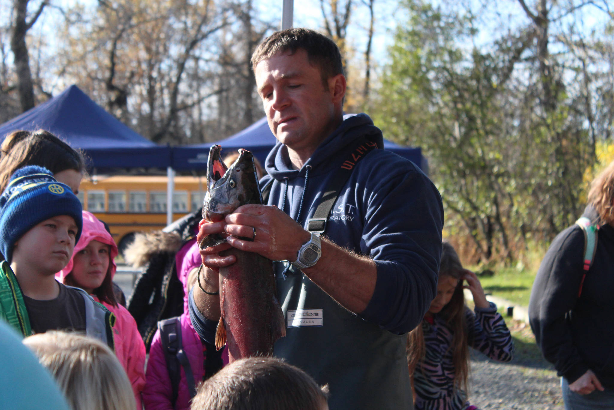 Tim Blackman with the Alaska Department of Fish and Game shows students from lower Kenai Peninsula schools the different parts of a coho salmon’s anatomy during an egg take event Thursday, Oct. 5, 2017 at the Anchor River in Anchor Point, Alaska. The egg take is the first event that kicks off the year-long Salmon in the Classroom program, in which students learn about the salmon life cycle while taking care of salmon fry. (Photo by Megan Pacer/Homer News)