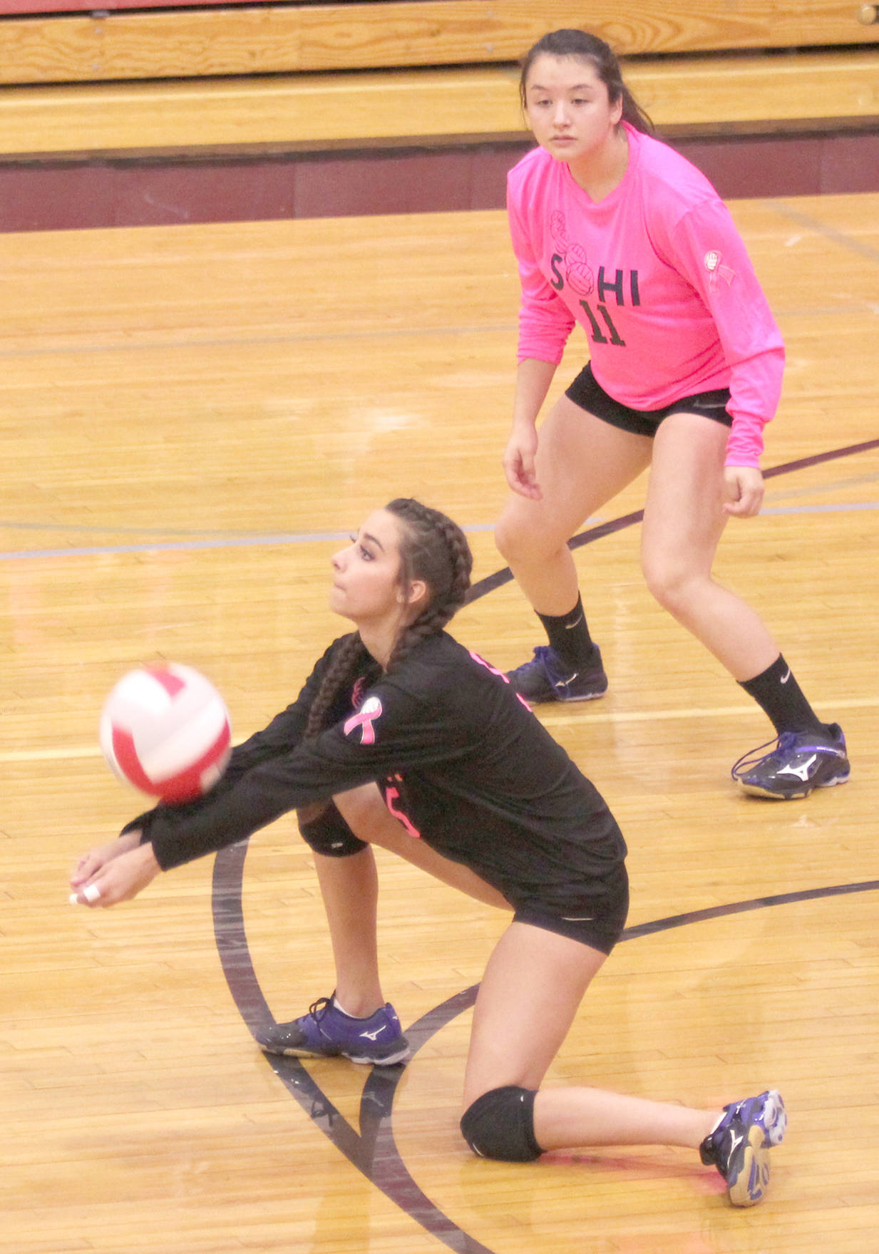 Soldotna’s Holleigh Jamie receives a serve as Shay Zener looks on during a 3-2 loss to Wasilla on Friday, Oct. 13, 2017, in Wasilla. (Photo by Jeremiah Bartz/Frontiersman)