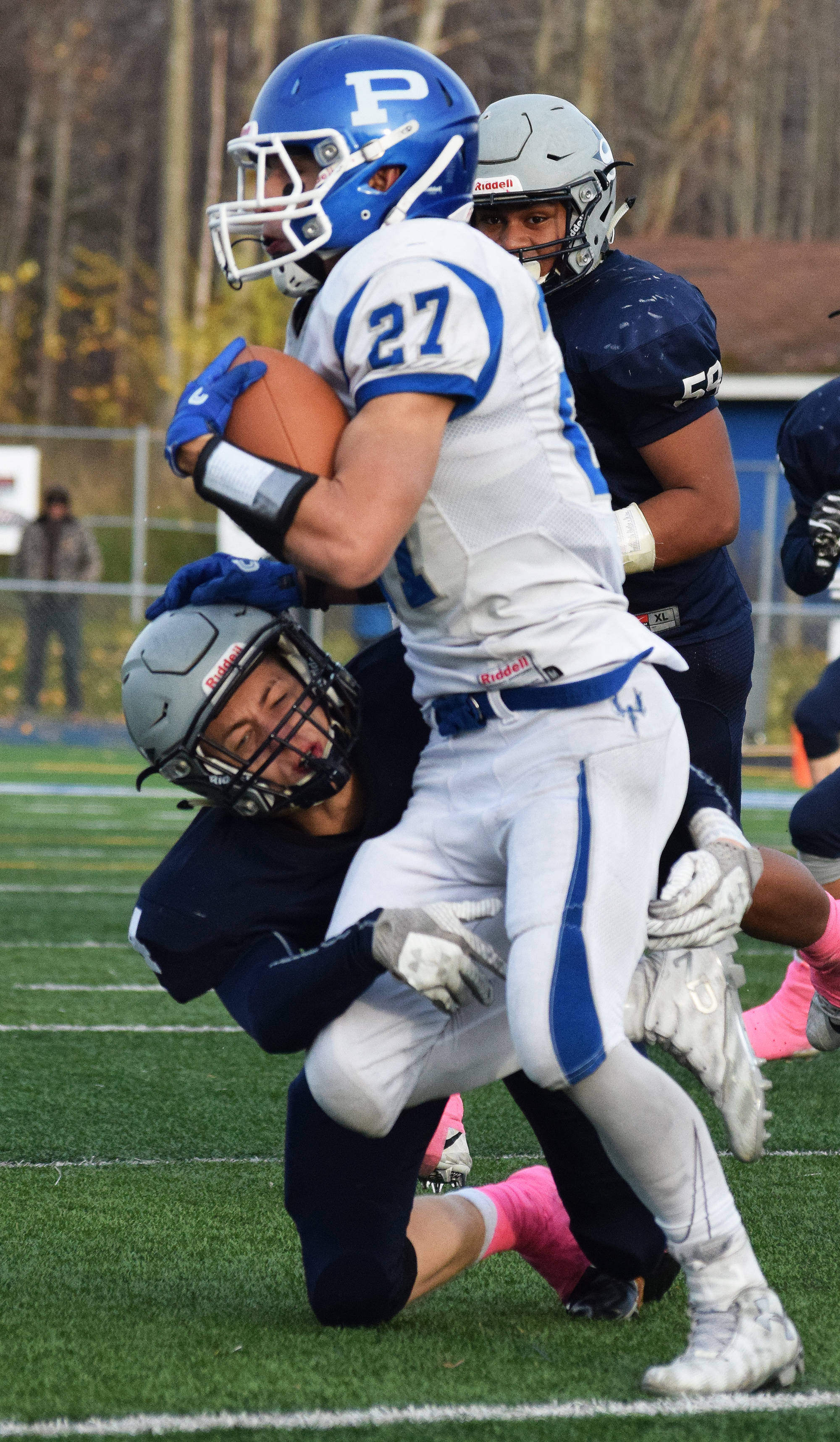 Soldotna sophomore Jersey Truesdell attempts to tackle Palmer running back Larry Cutsforth (27) Saturday in the ASAA First National Bank Division II state championship at Machetanz Field in Palmer. (Photo by Joey Klecka/Peninsula Clarion)