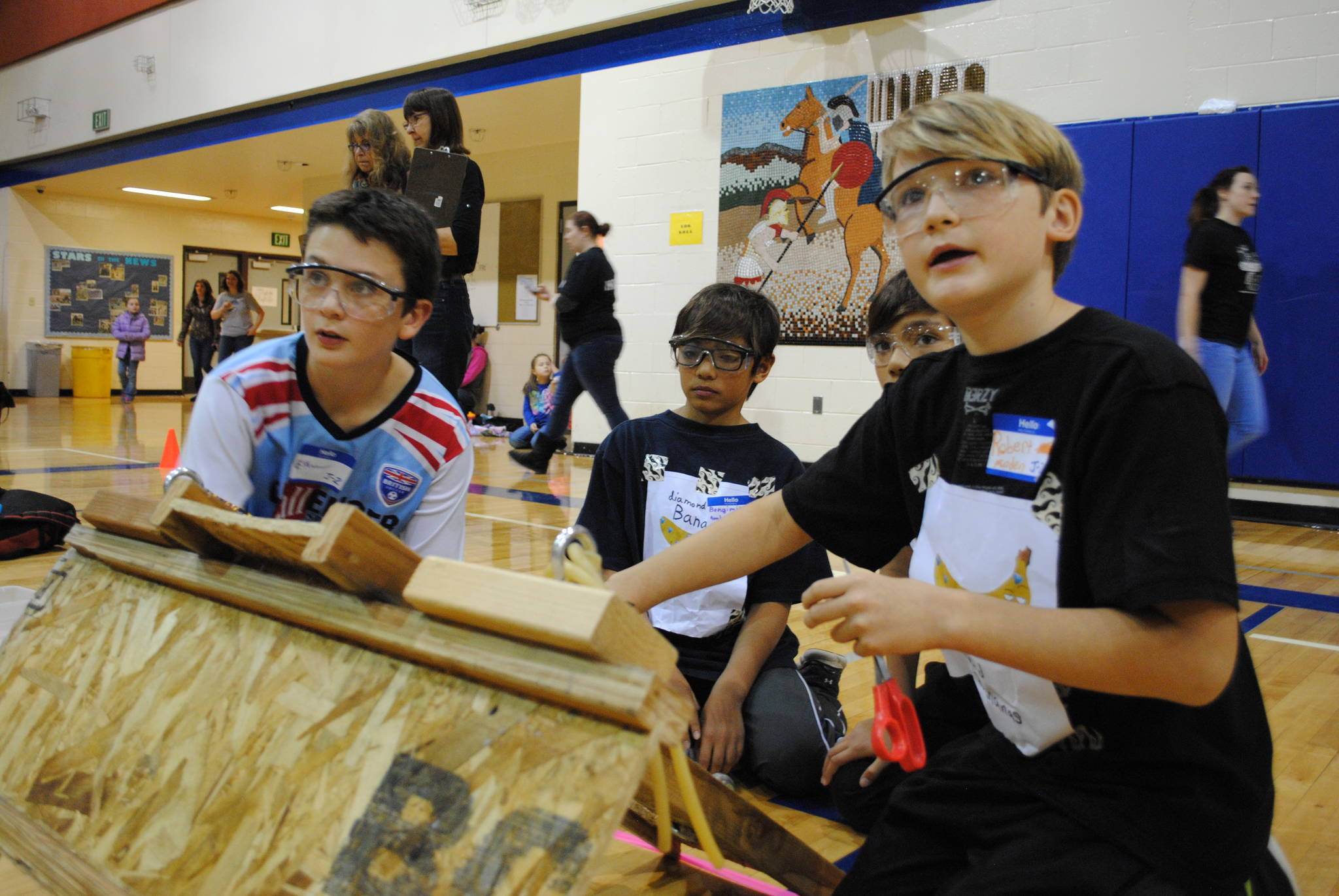 The Diamond Bananas, also known as Ethan Williams, left, Bengimin Ambrosian, Nickolas Ambrosian and Robert Minden of Seward Middle School, prepare their catapult for the Mind A-Mazes challenge at Soldotna Prep School in Soldotna, Alaska on Saturday, October 14, 2017. Their device had to shoot a rubber ball into a wastebasket from different distances. (Photo by Kat Sorensen/Peninsula Clarion)